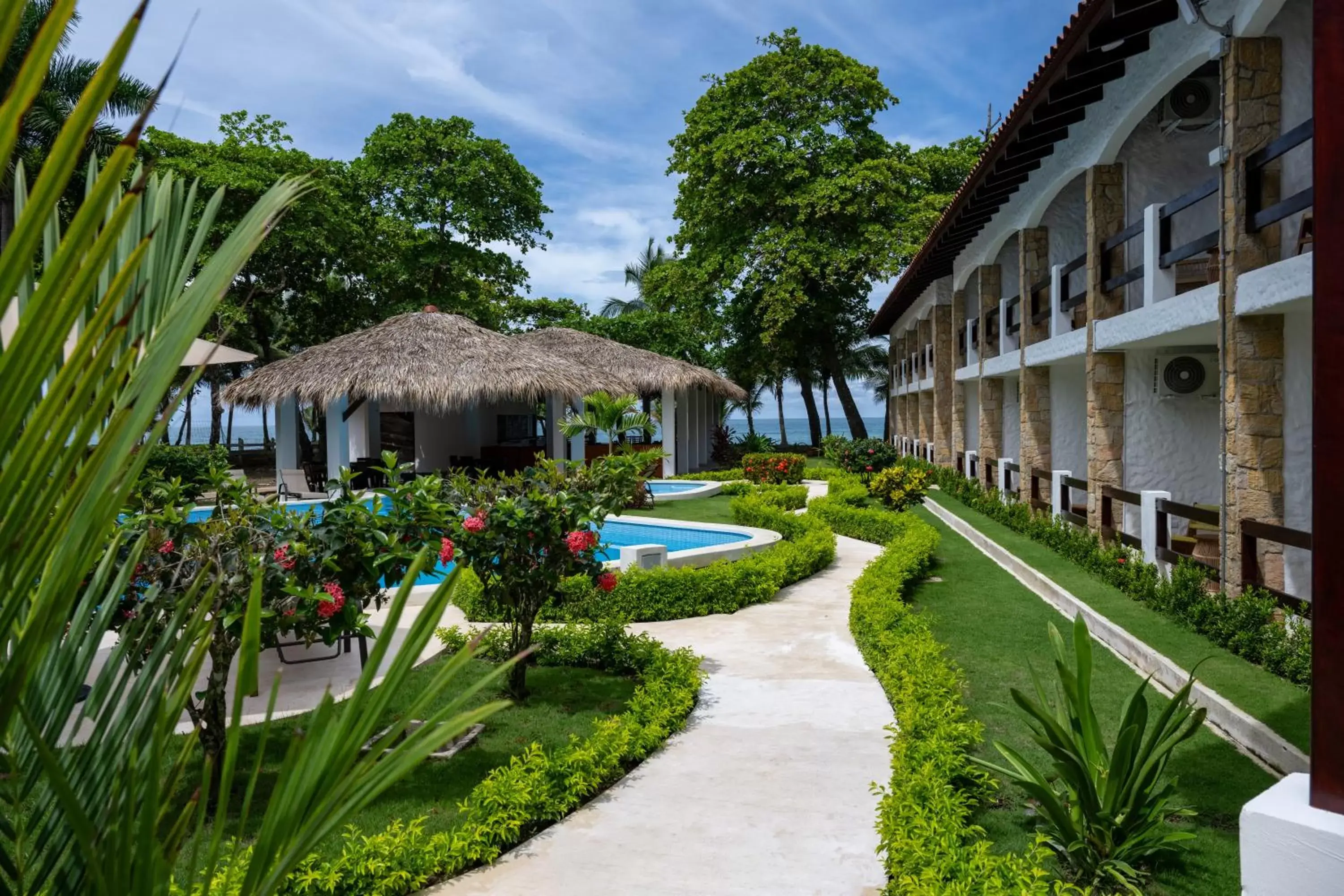 Swimming pool, Property Building in Fuego del Sol Beachfront Hotel