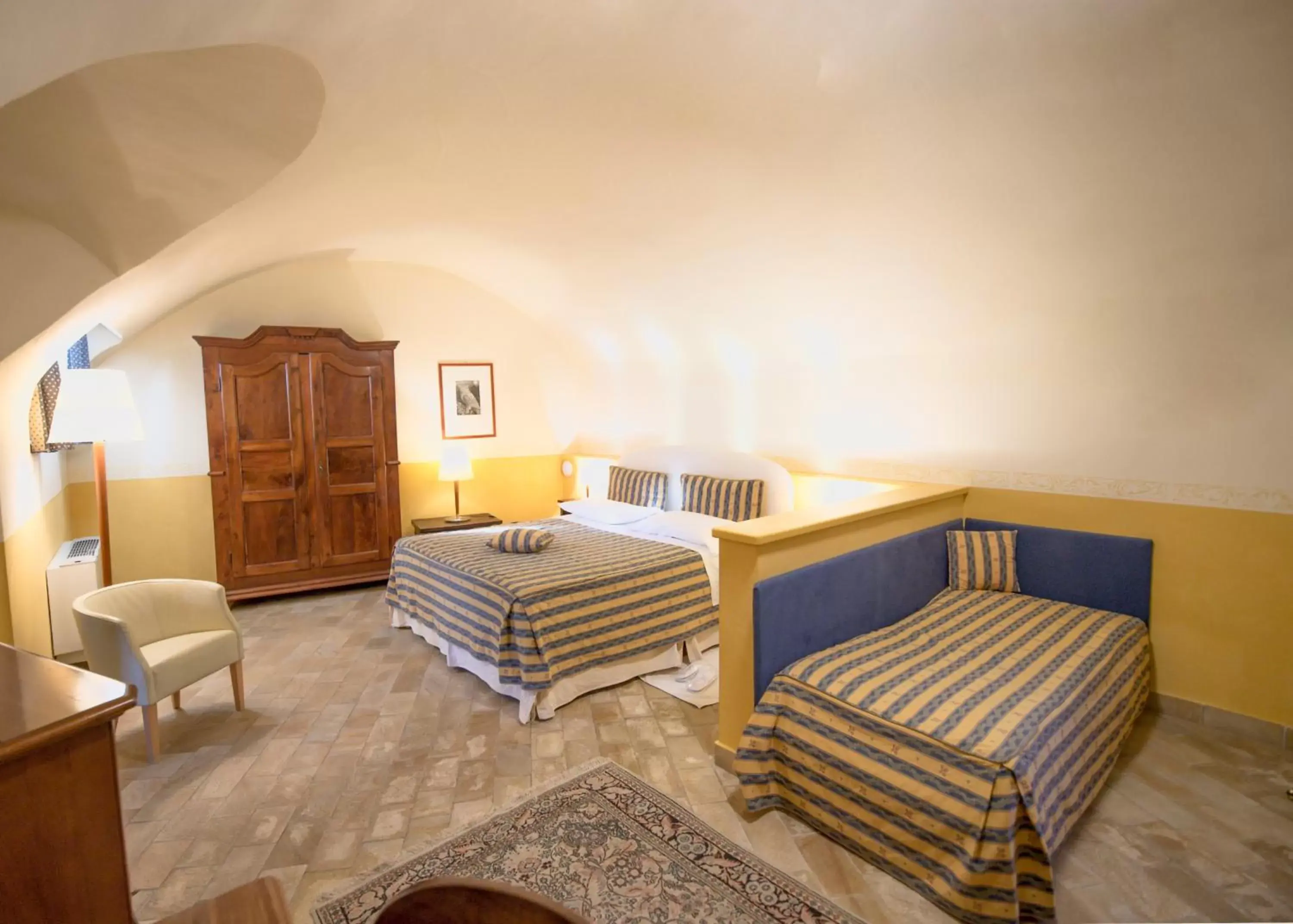 Bed, Seating Area in Castello Rosso