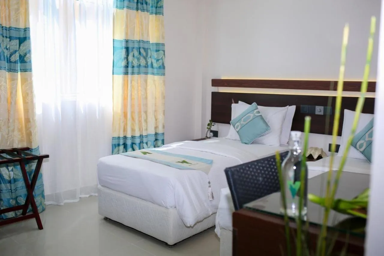 Bed in The White Harp Beach Hotel