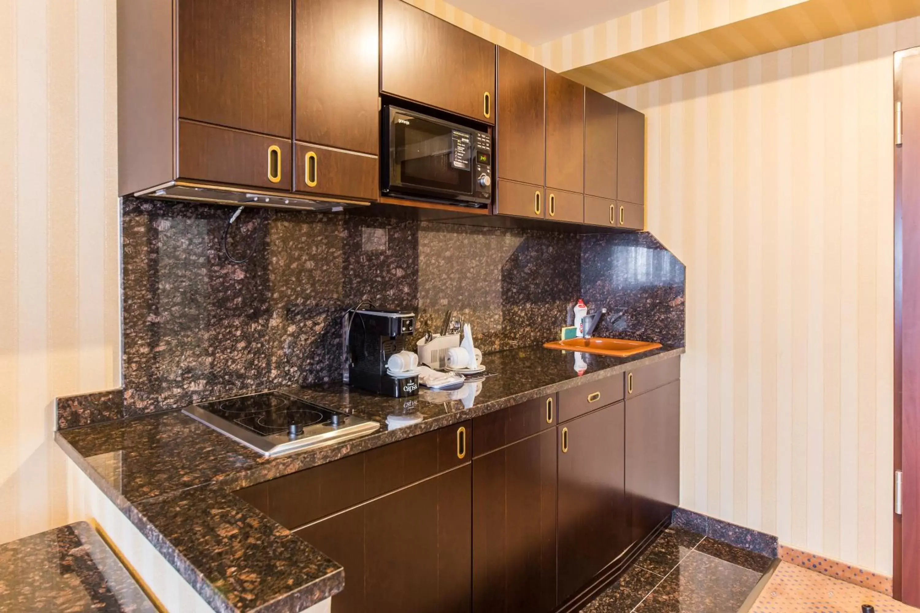 Kitchen/Kitchenette in Ramada Hotel & Suites by Wyndham Bucharest North