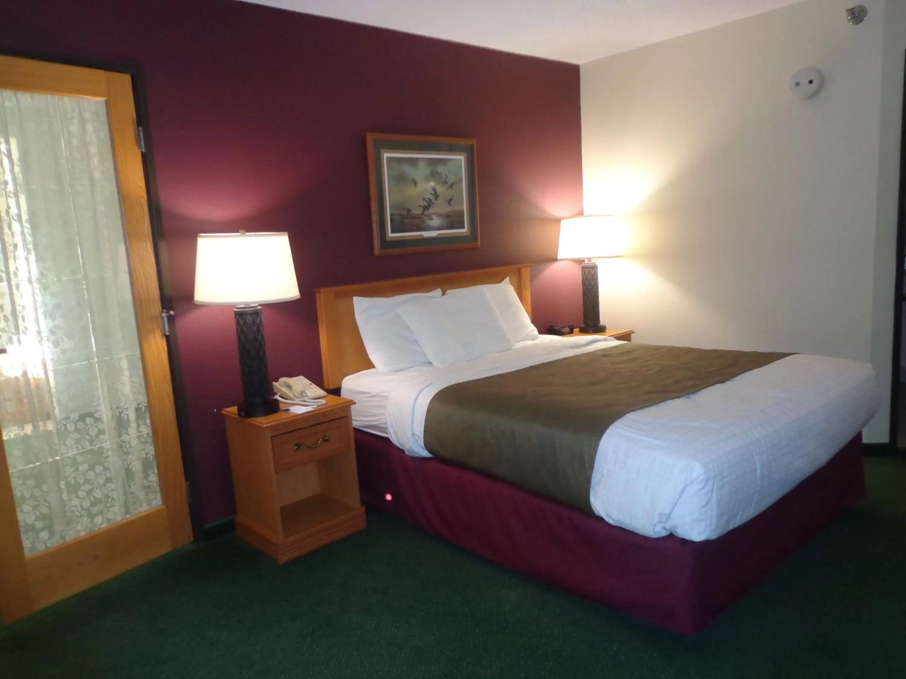 Bed in AmericInn by Wyndham Madison SD