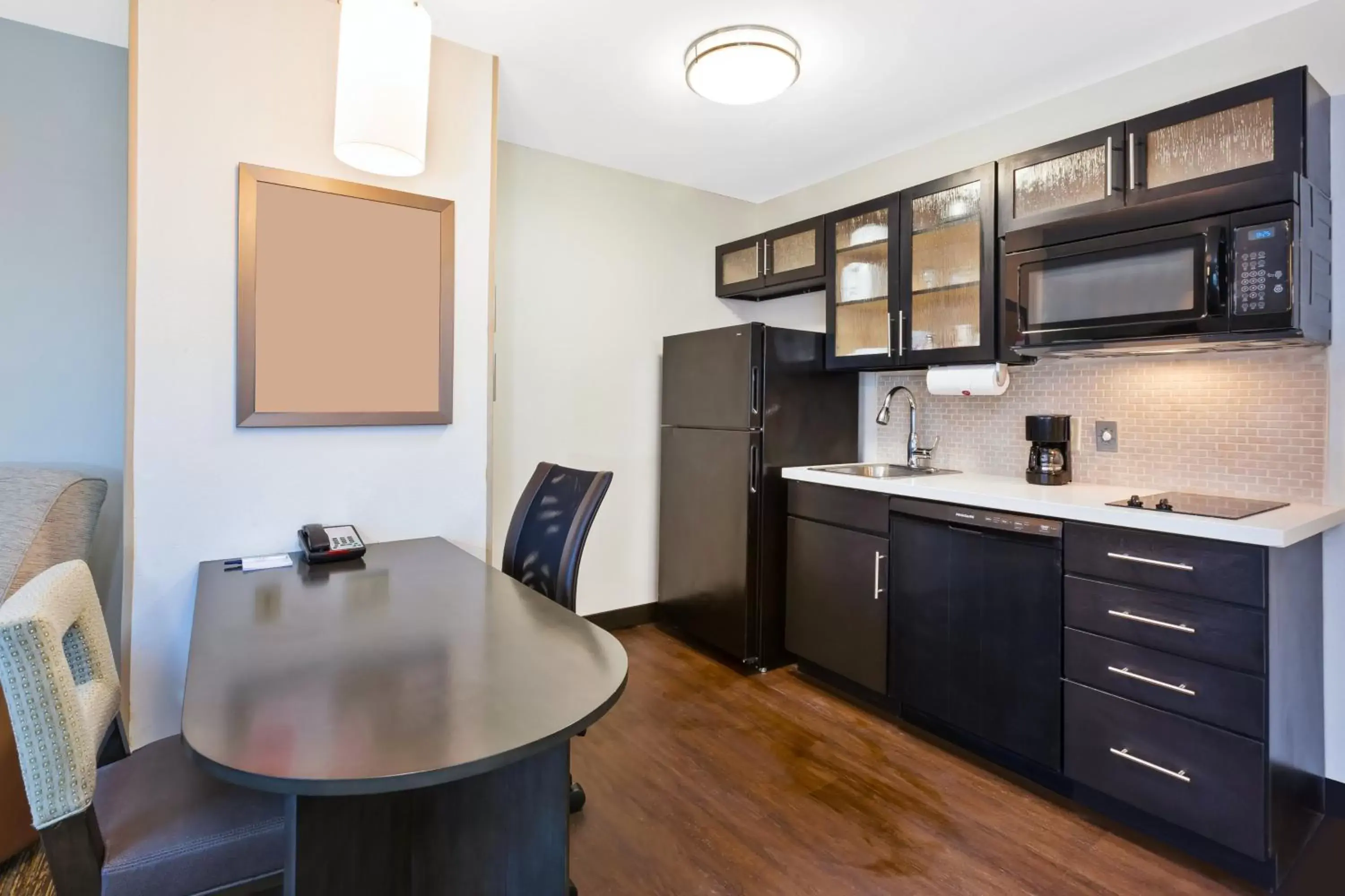 Photo of the whole room, Kitchen/Kitchenette in Candlewood Suites Huntersville-Lake Norman Area, an IHG Hotel