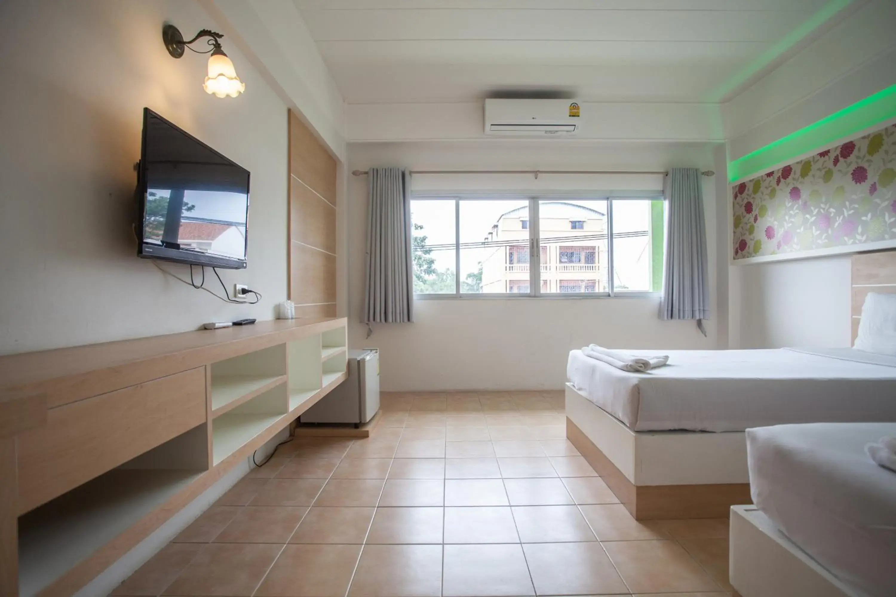 Photo of the whole room, TV/Entertainment Center in The Greenery Hotel