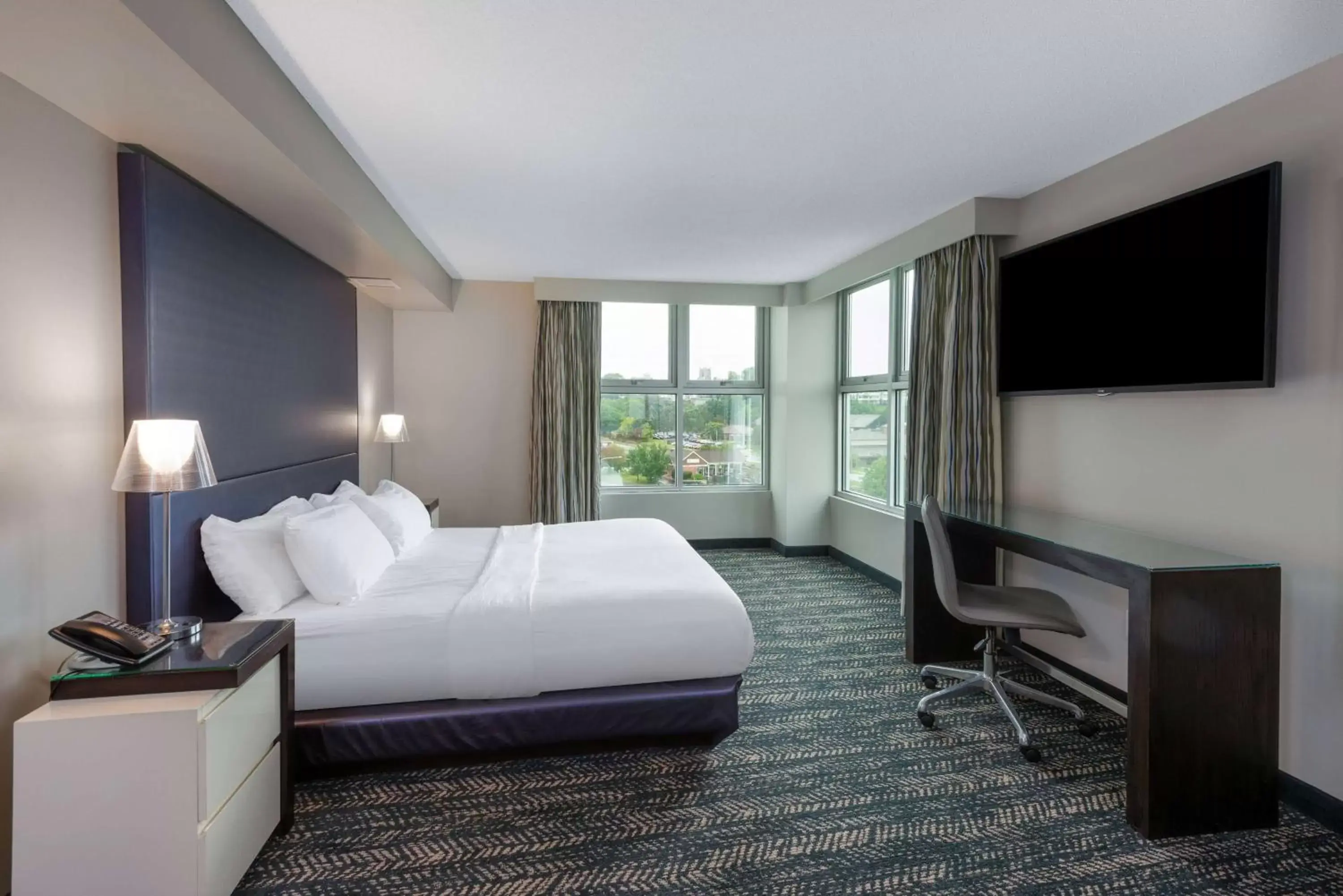 Bed, TV/Entertainment Center in 41 Lakefront Hotel, Trademark Collection by Wyndham