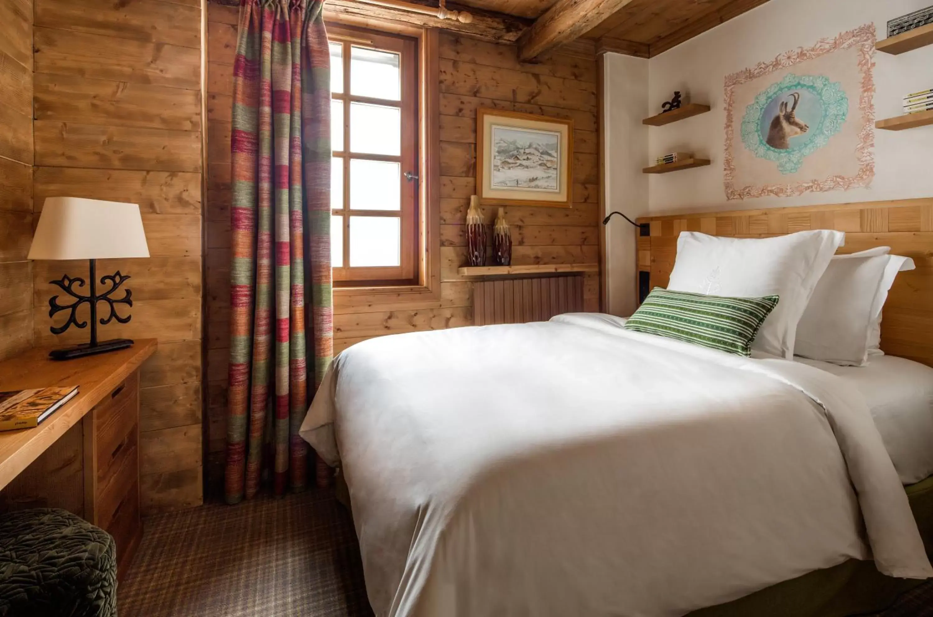 Bed in Les Chalets du Mont d'Arbois Megeve, a Four Seasons Hotel
