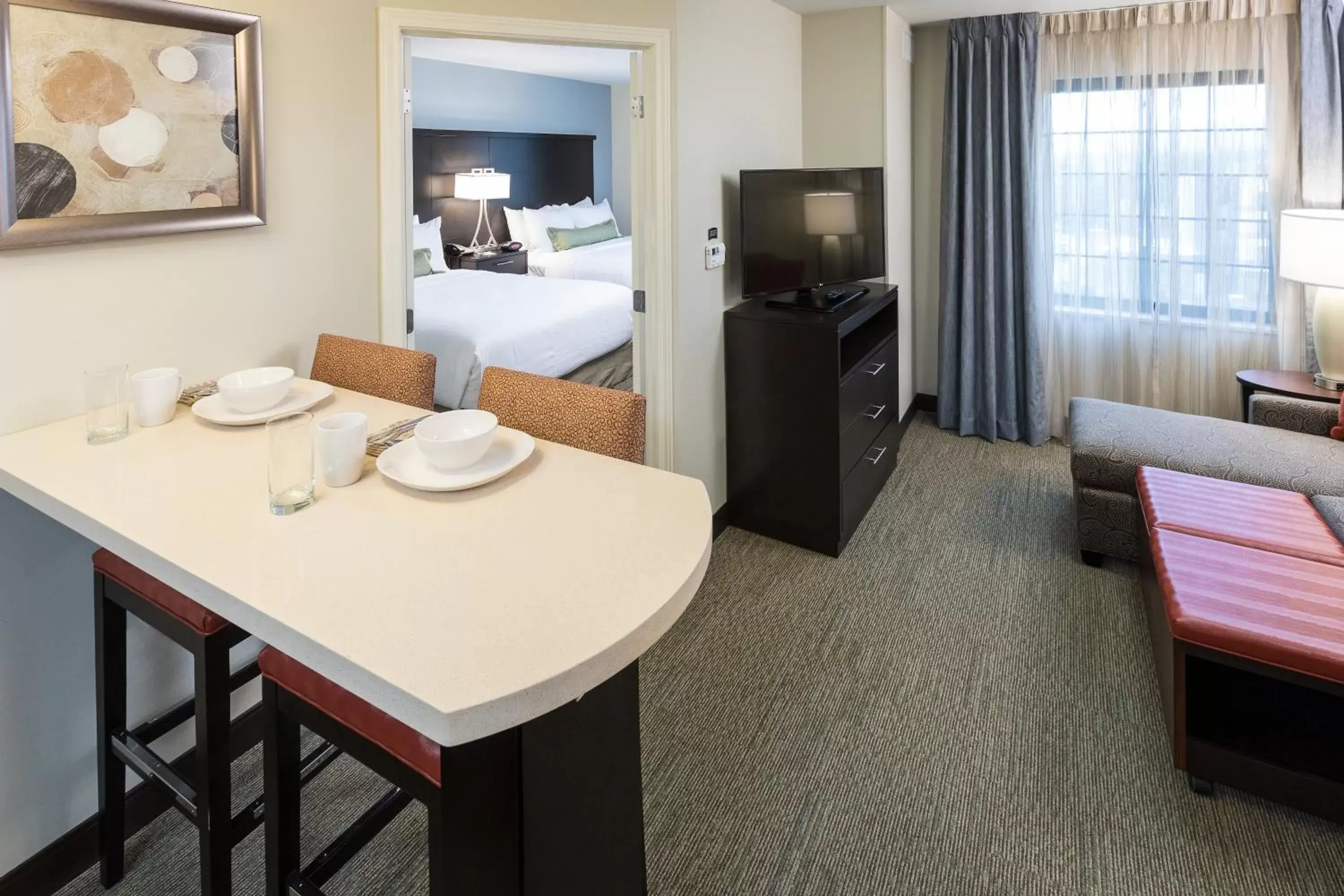 Bedroom, TV/Entertainment Center in Staybridge Suites Omaha West, an IHG Hotel
