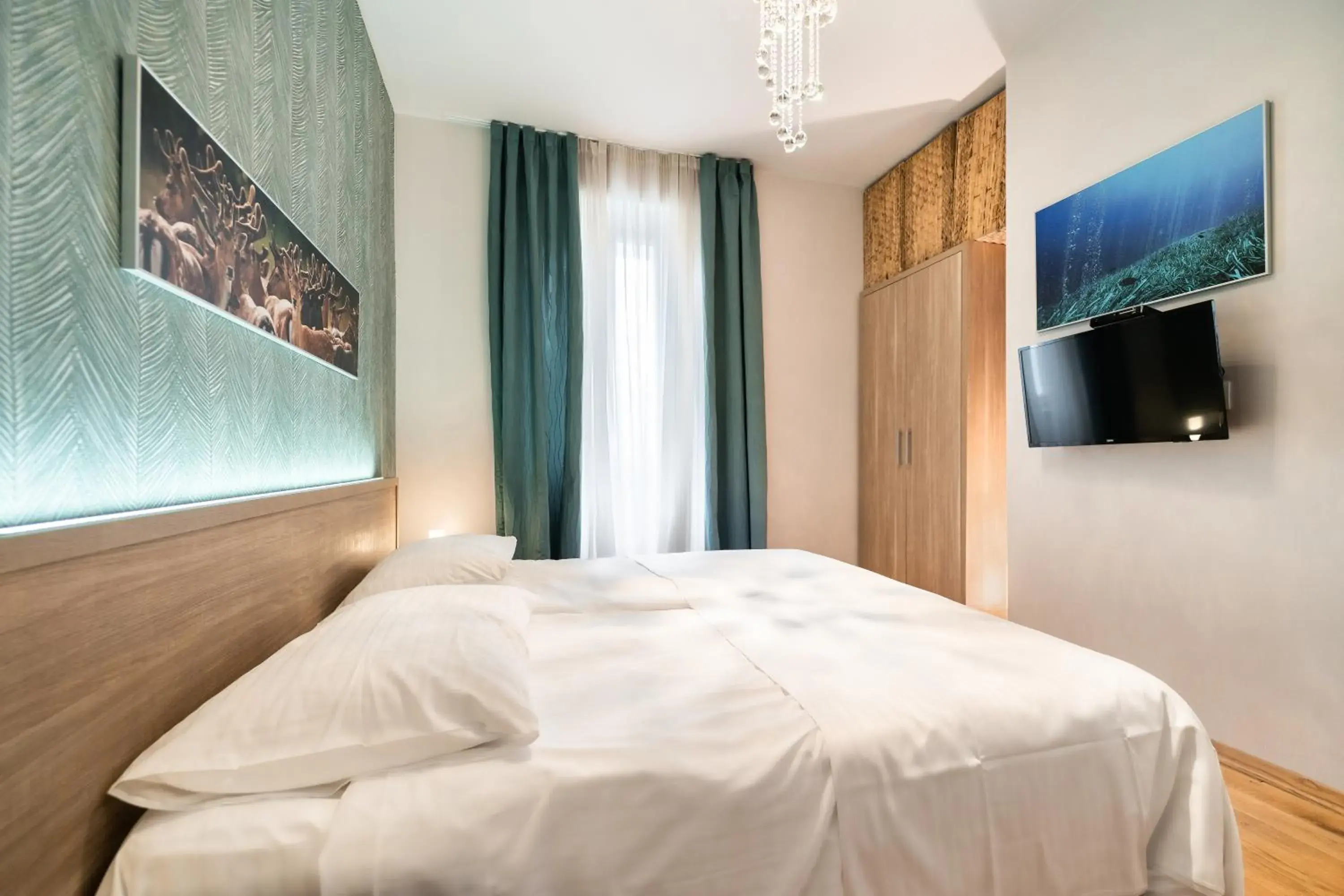 Bed in Tifani Luxury Rooms