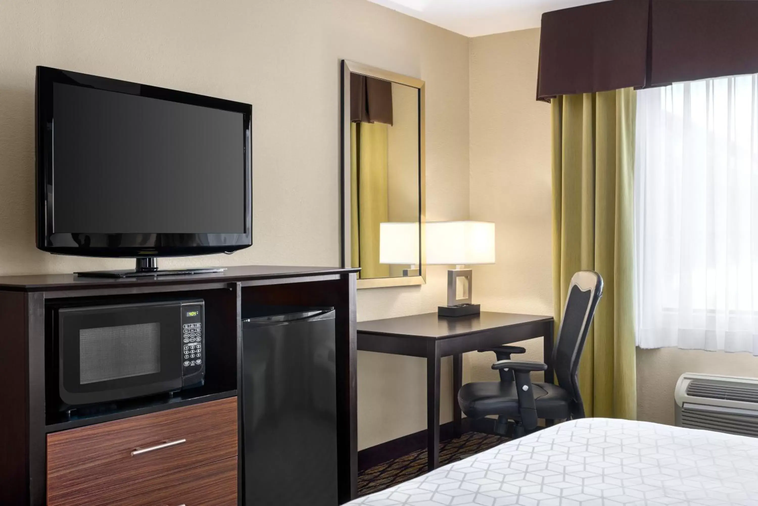 Photo of the whole room, TV/Entertainment Center in Holiday Inn Express Hotel & Suites Edmond, an IHG Hotel