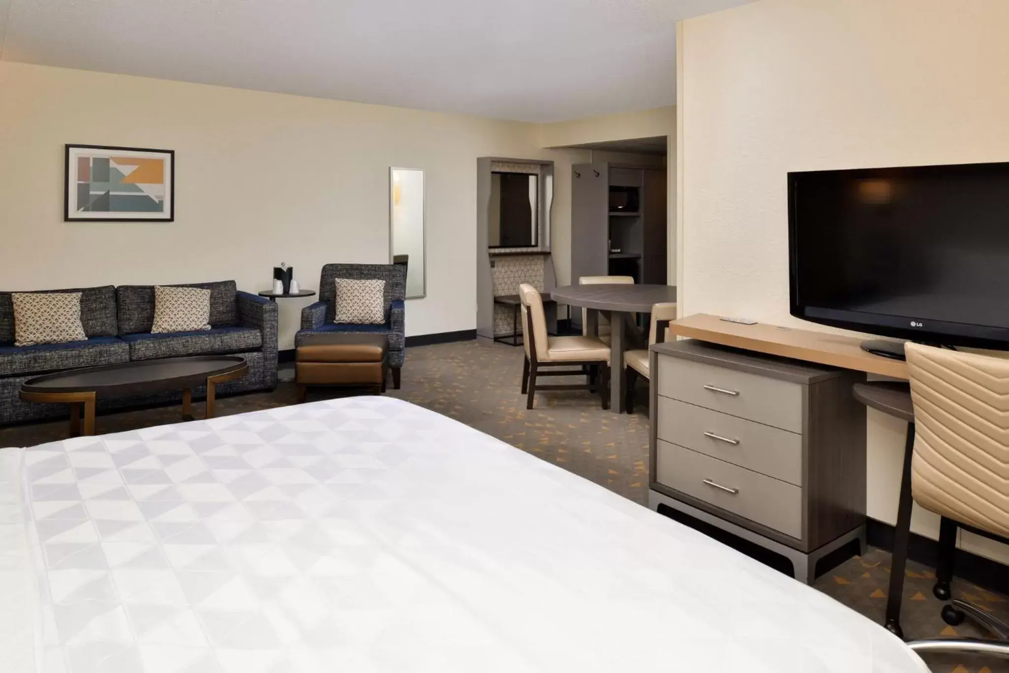 Photo of the whole room, TV/Entertainment Center in Holiday Inn Hotel & Suites Overland Park-Convention Center, an IHG Hotel