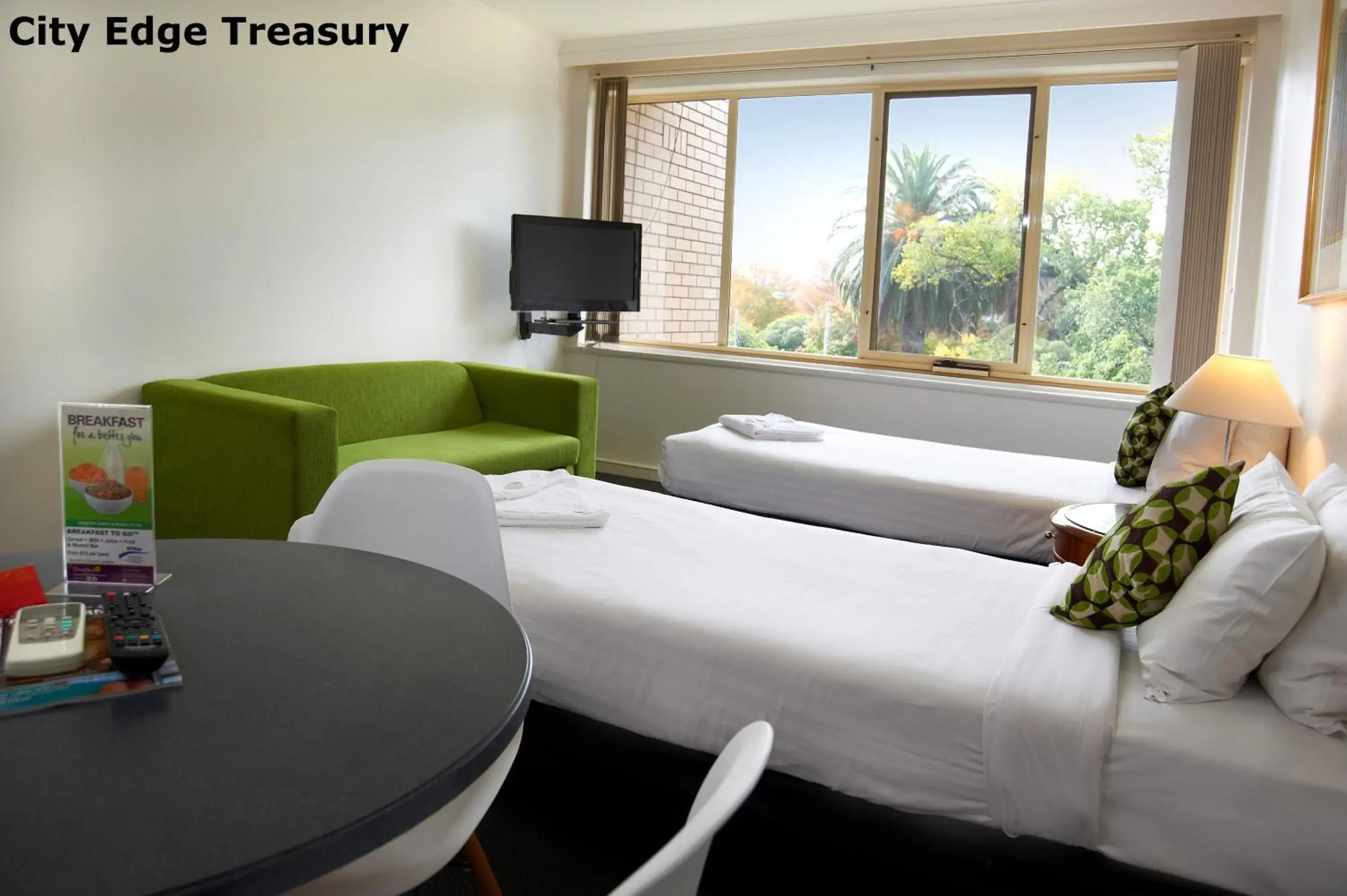 Seating area in City Edge East Melbourne Apartment Hotel