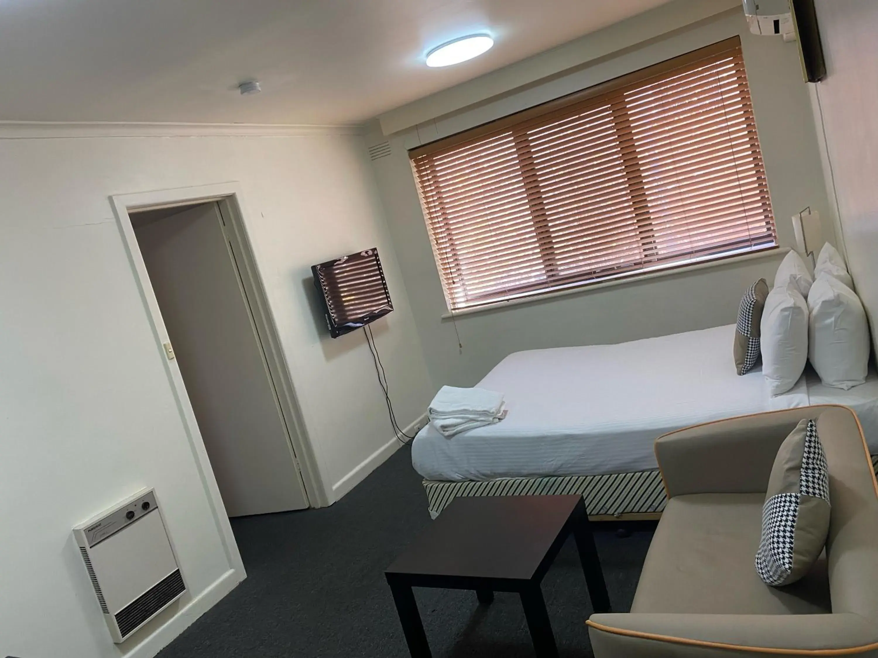 Seating area, Bed in City Edge East Melbourne Apartment Hotel