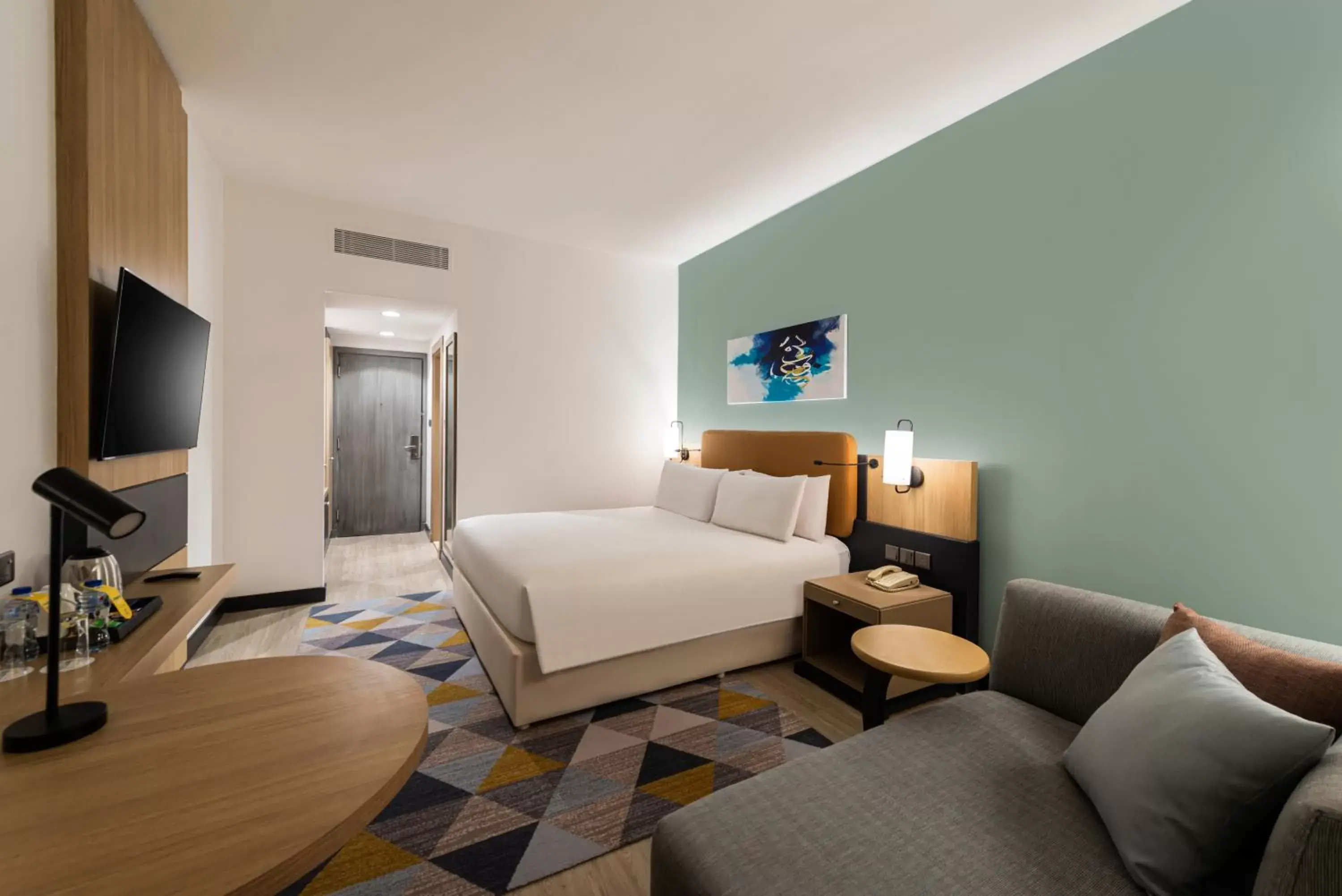 Communal lounge/ TV room, Bed in Holiday Inn Riyadh Al Qasr by IHG Communal lounge/ TV room, Bed in Holiday Inn Riyadh Al Qasr by IHG