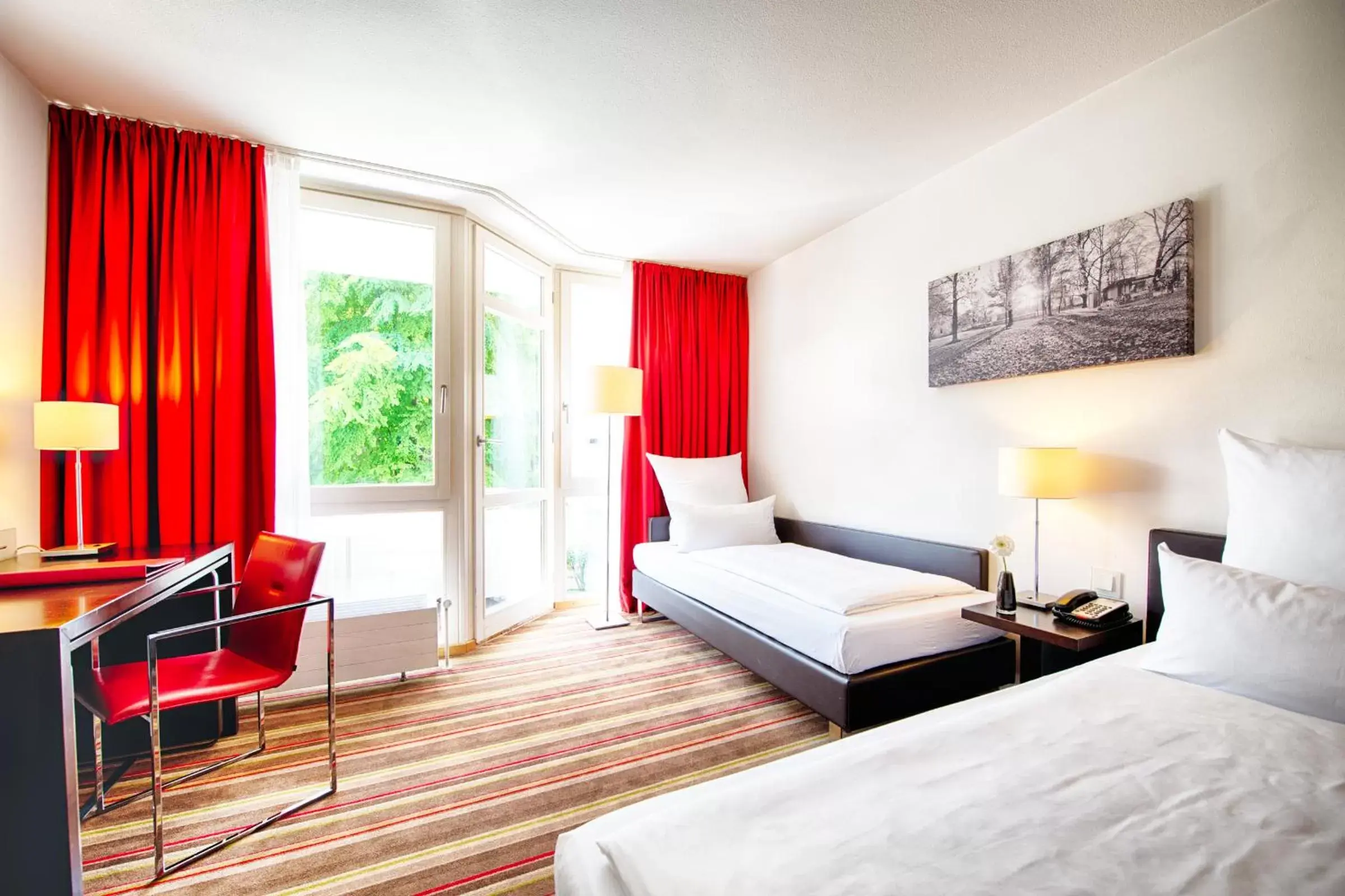 Bedroom, Seating Area in Leonardo Hotel München City West