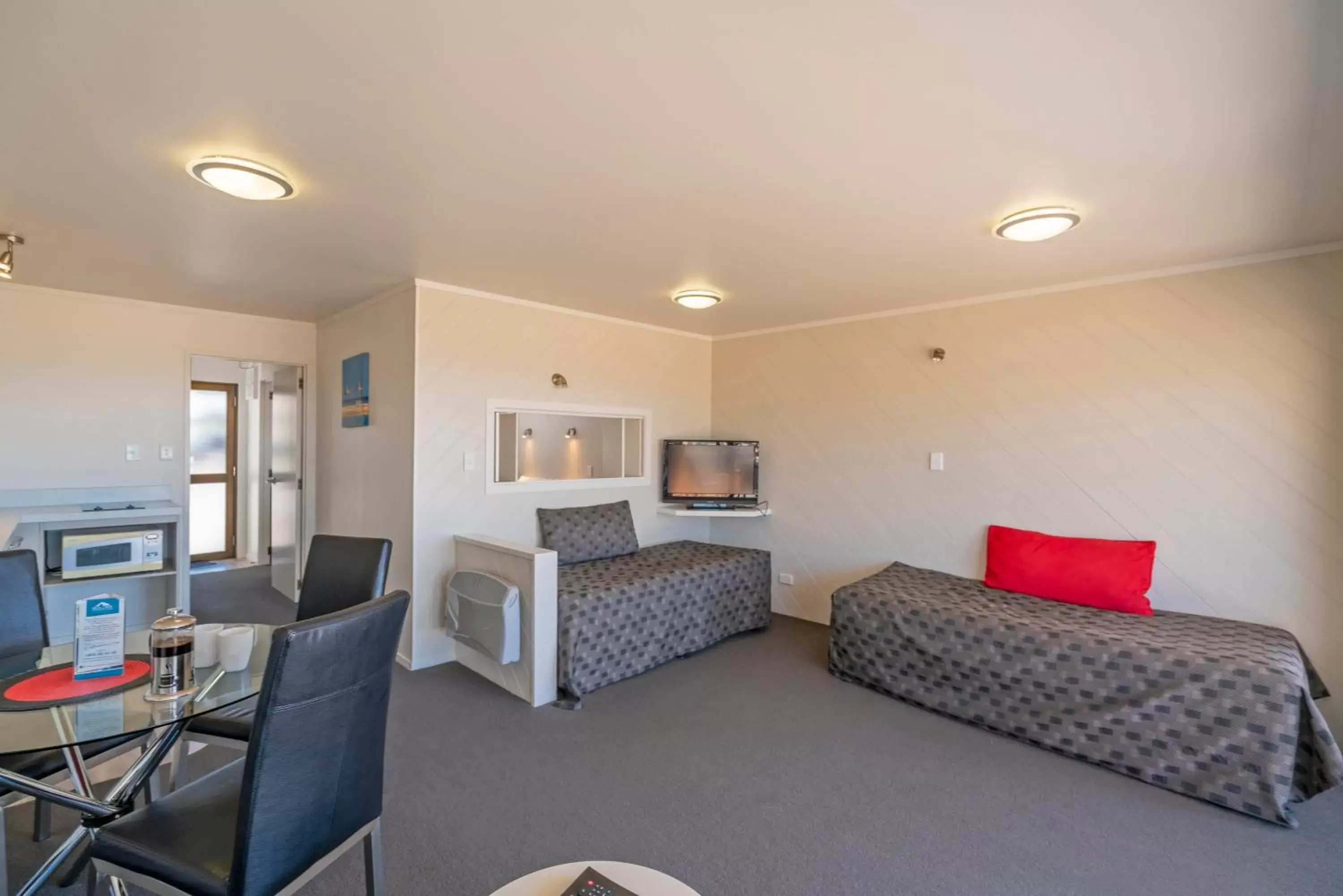 Bed, Seating Area in The Oceanside Motel