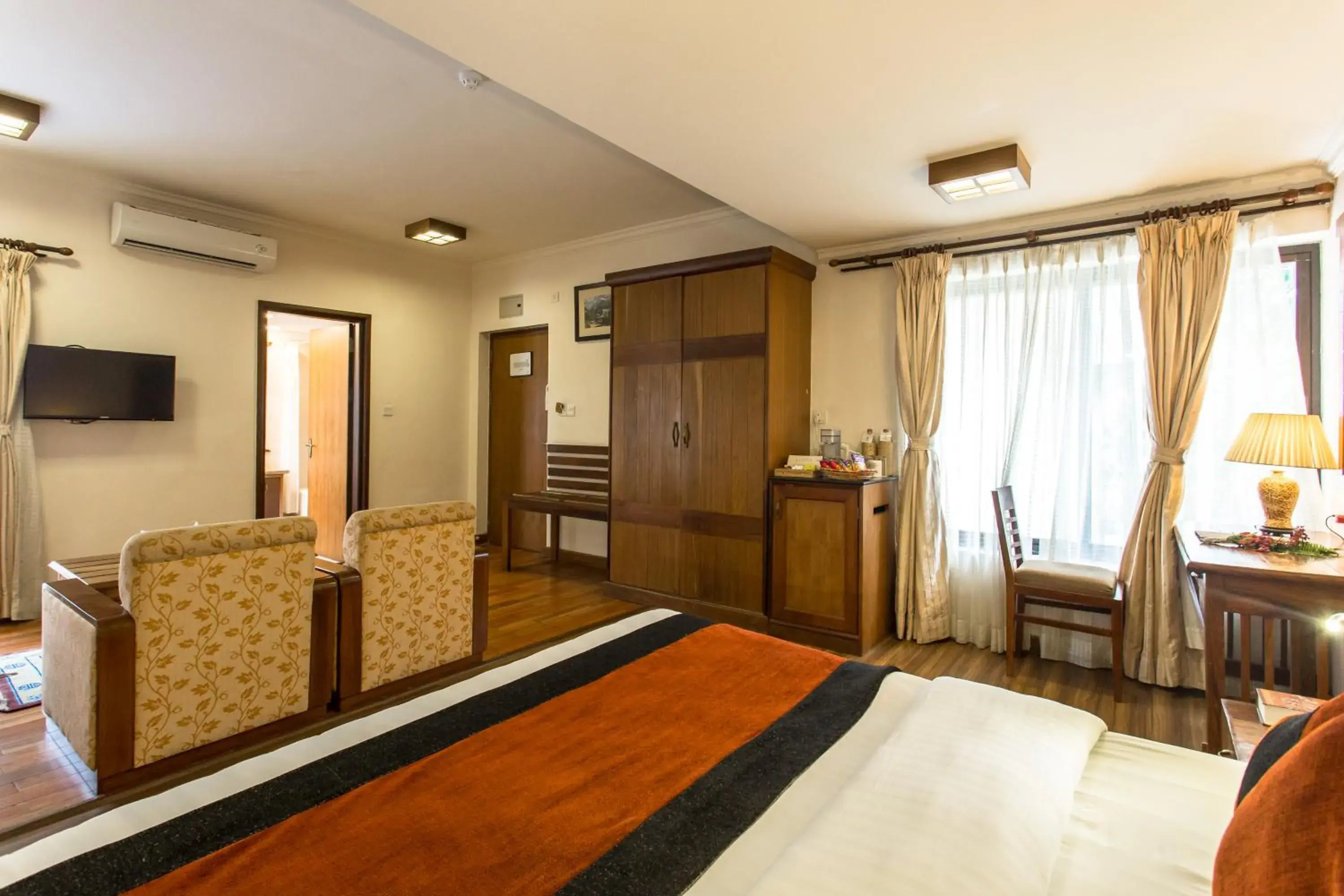 Bedroom, TV/Entertainment Center in Atithi Resort & Spa