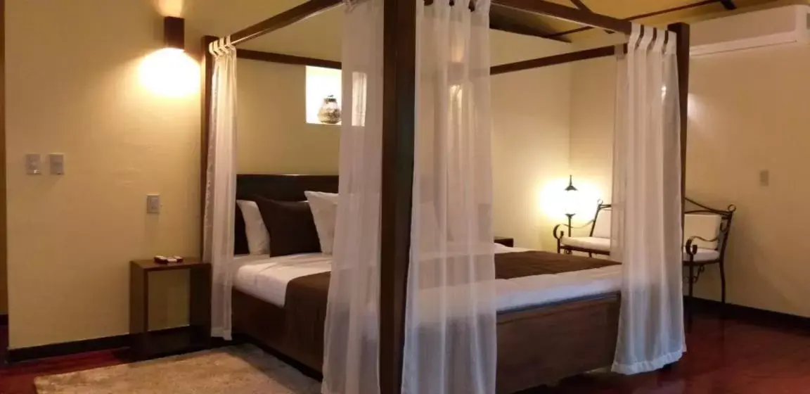 Bed in Tropical Suites & Villas