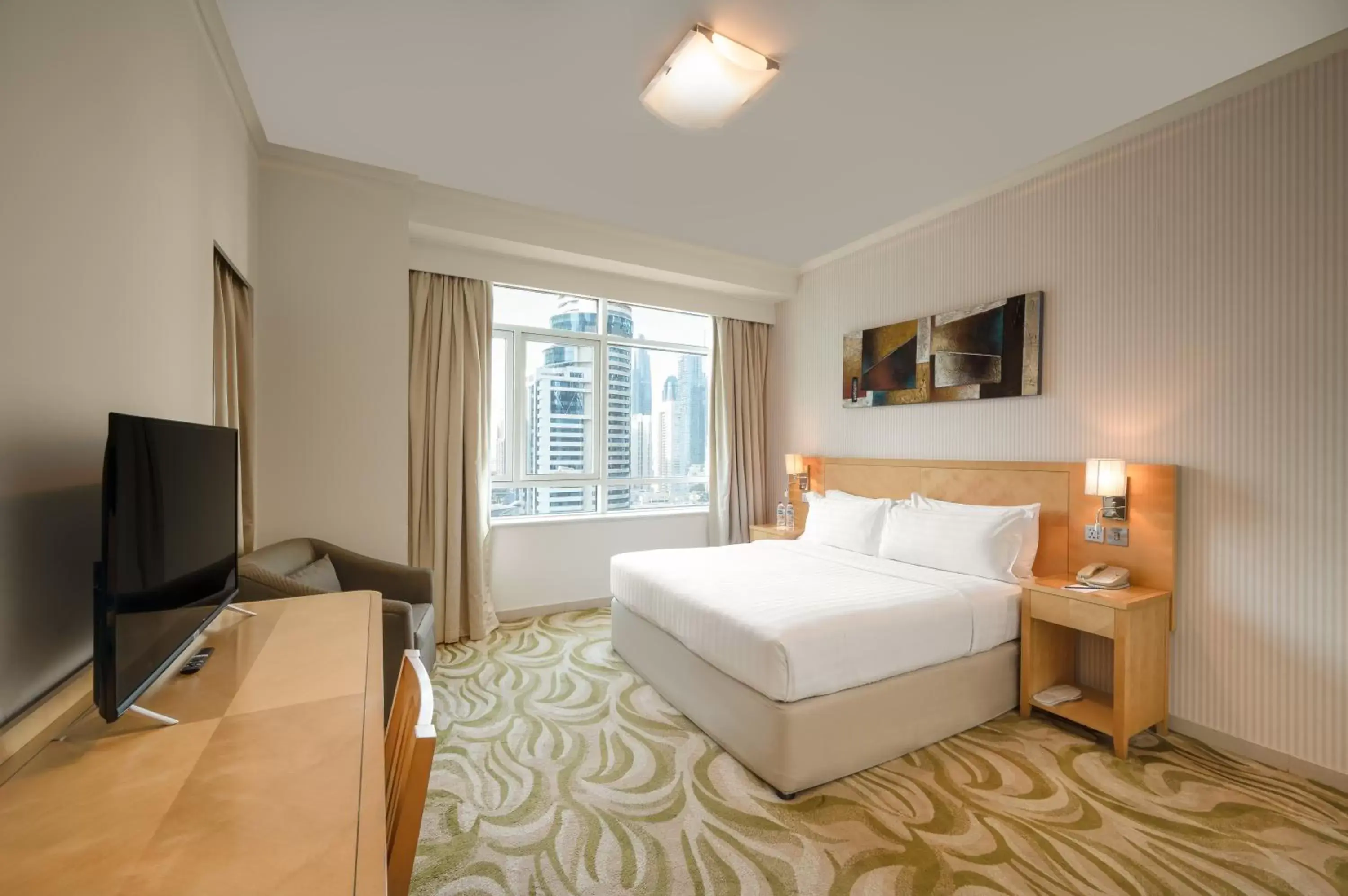 Bed in Oaks Liwa Heights Hotel Suites