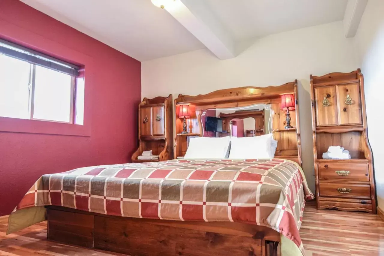 Bed in Brown & Hawkins Historical Apartments