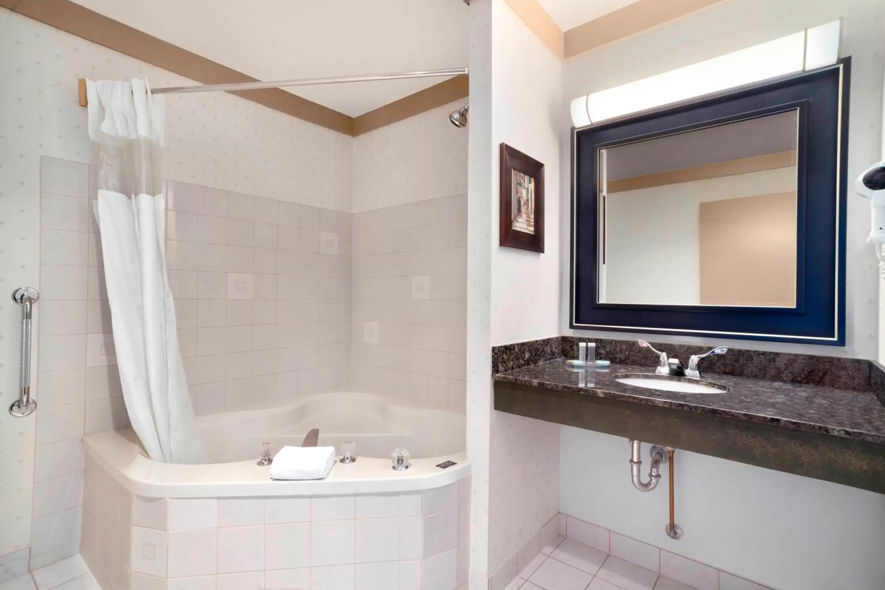 Bathroom in Days Inn & Suites by Wyndham Sault Ste. Marie ON