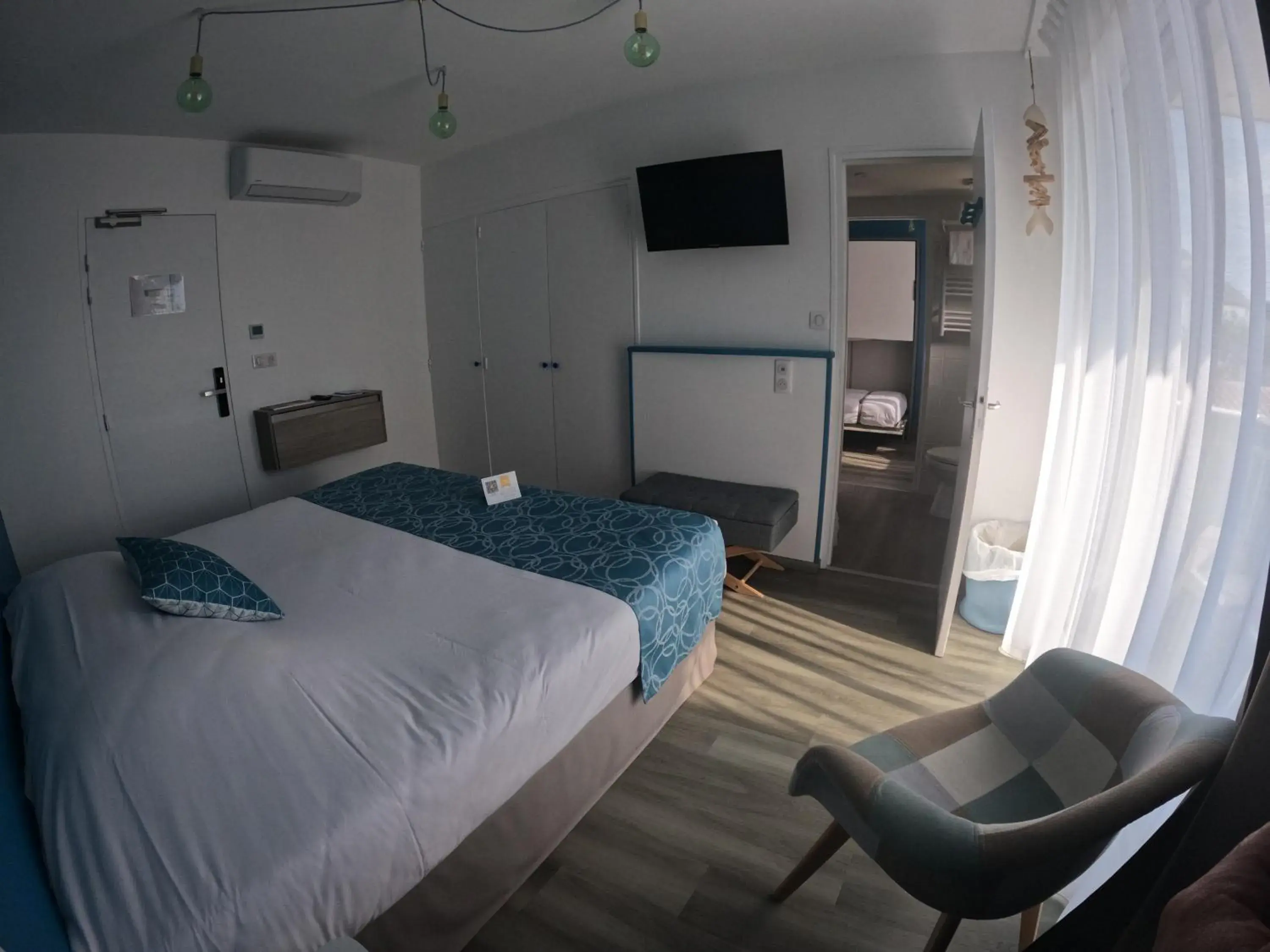 Communal lounge/ TV room, Bed in Hôtel La Côte Océane