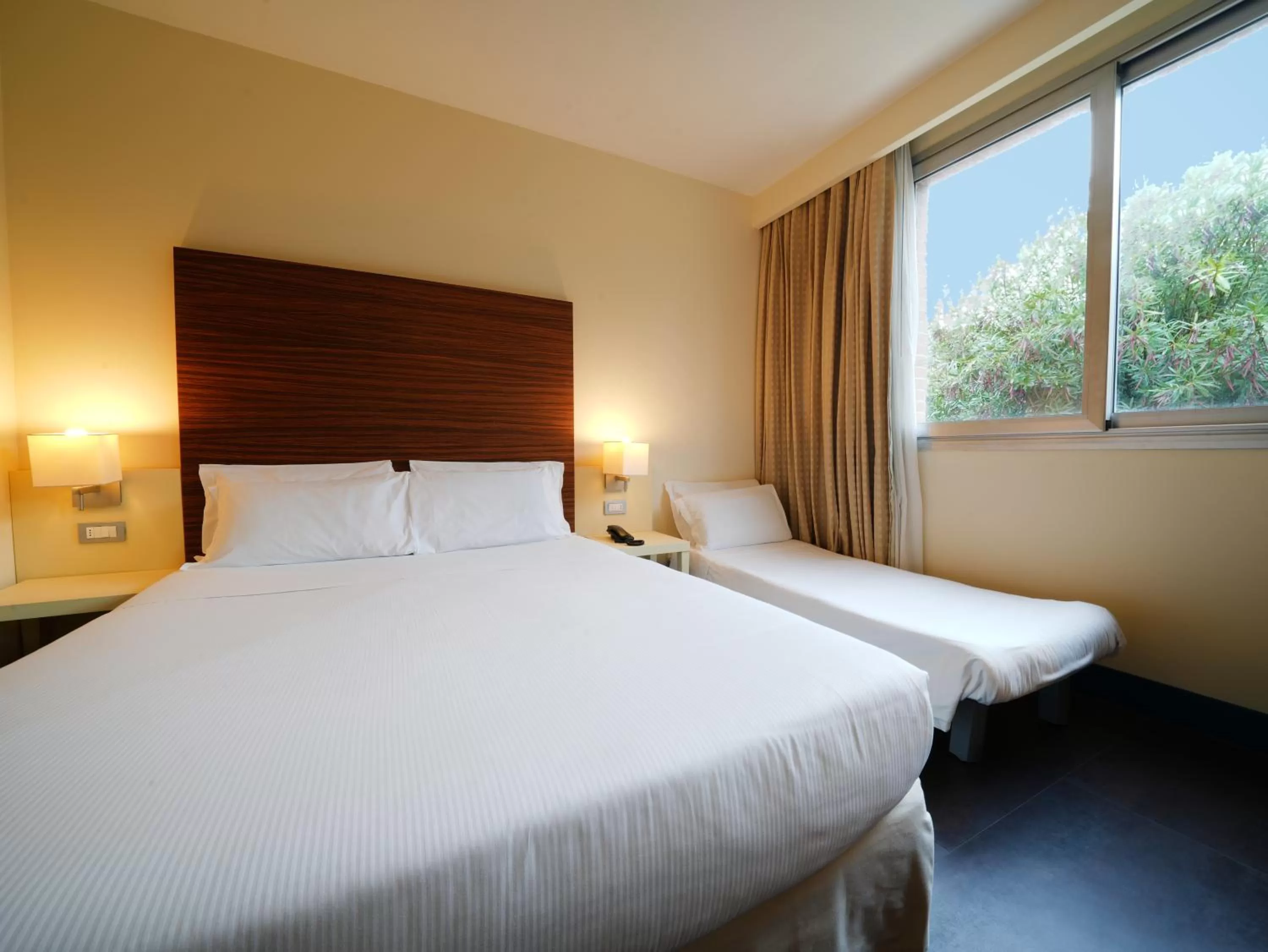 Bed in La Meridiana Bleisure Hotel