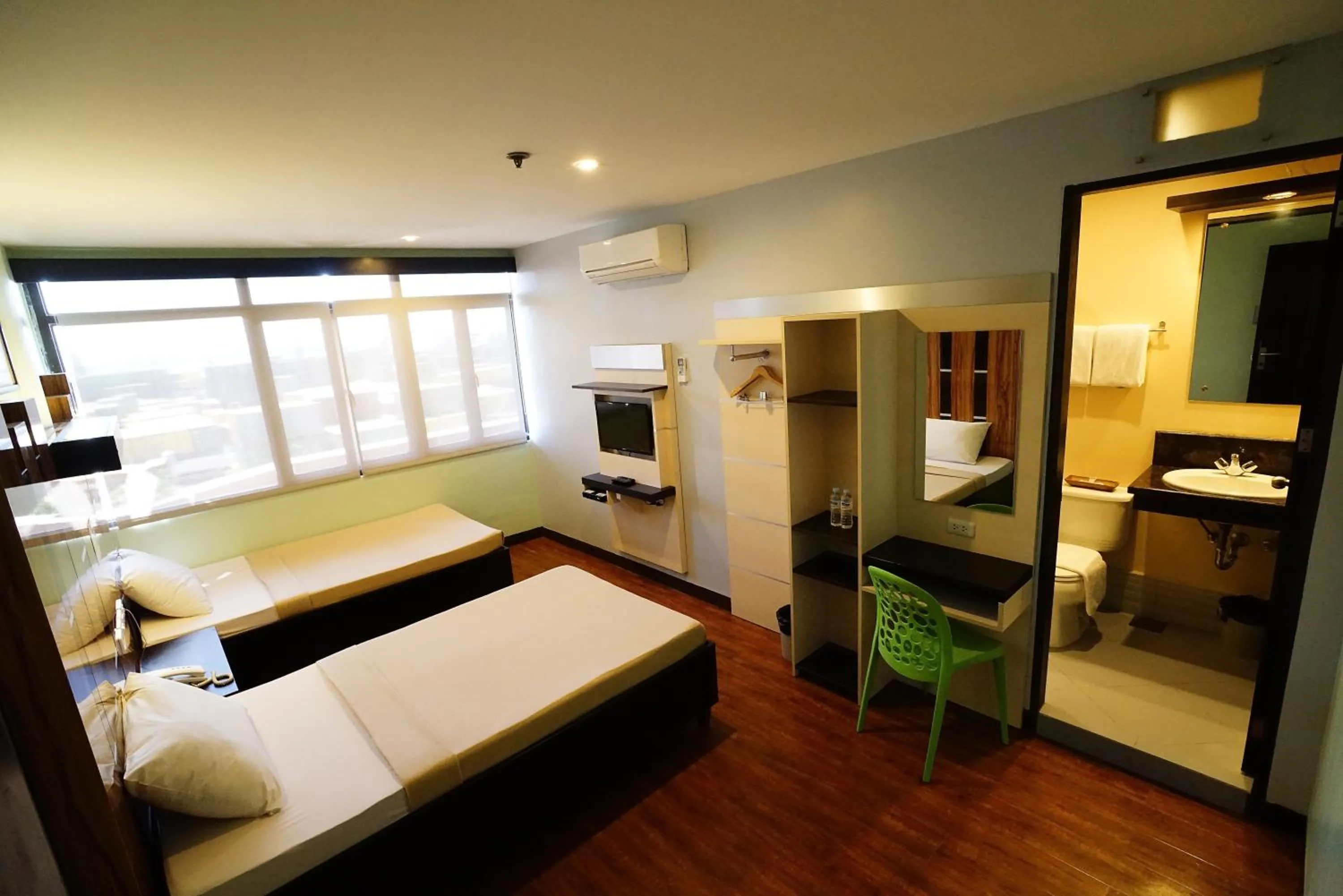 Photo of the whole room, Bed in Sugbutel Family Hotel Cebu powered by Cocotel