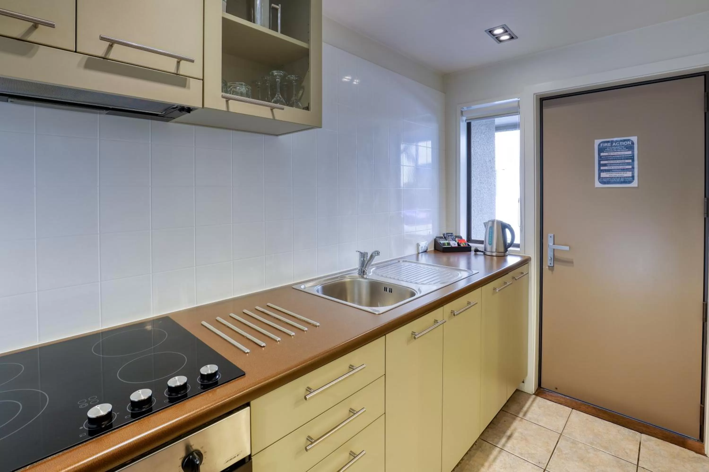 kitchen in Garden Court Suites & Apartments