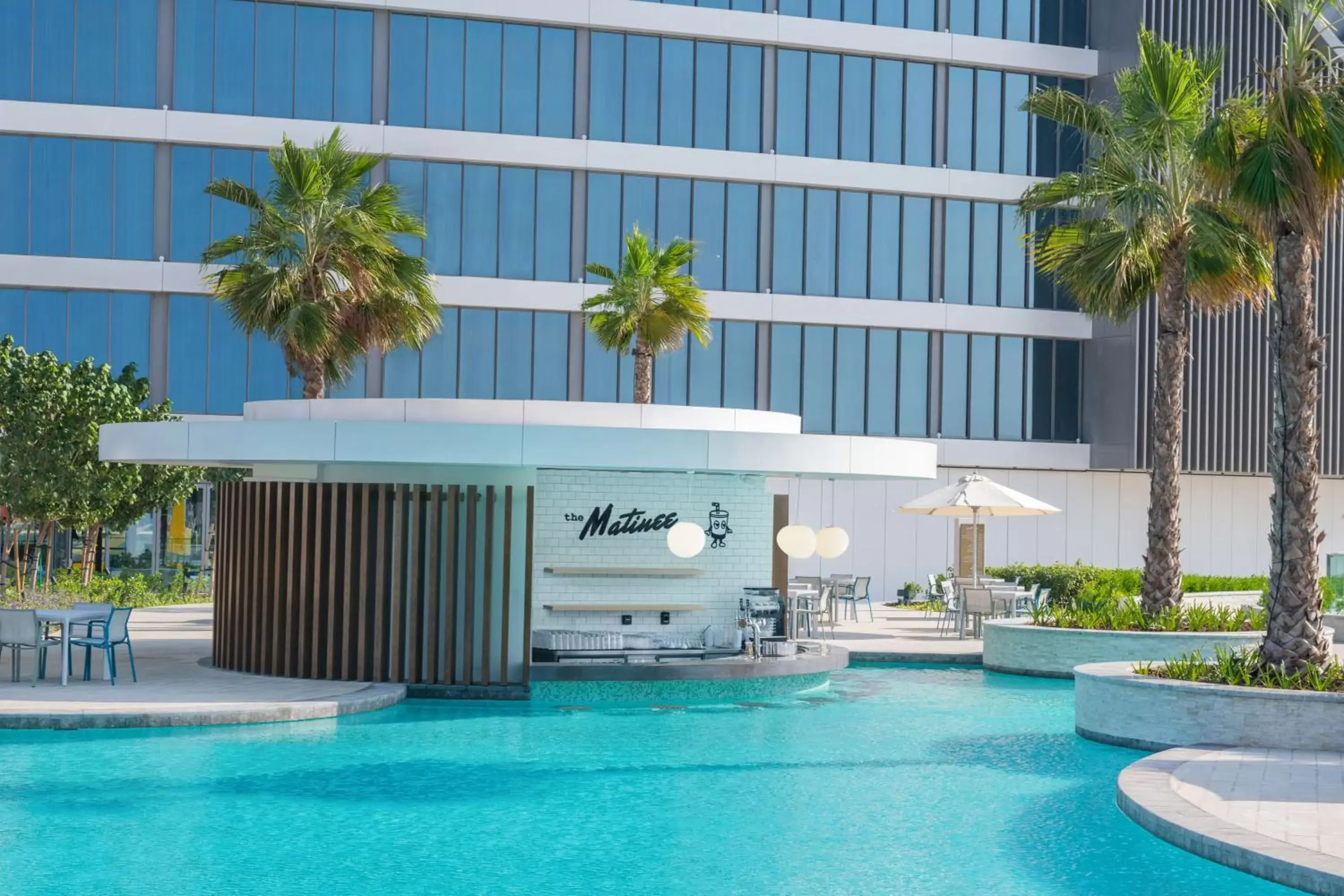 Dining area, Swimming Pool in The WB Abu Dhabi, Curio Collection By Hilton