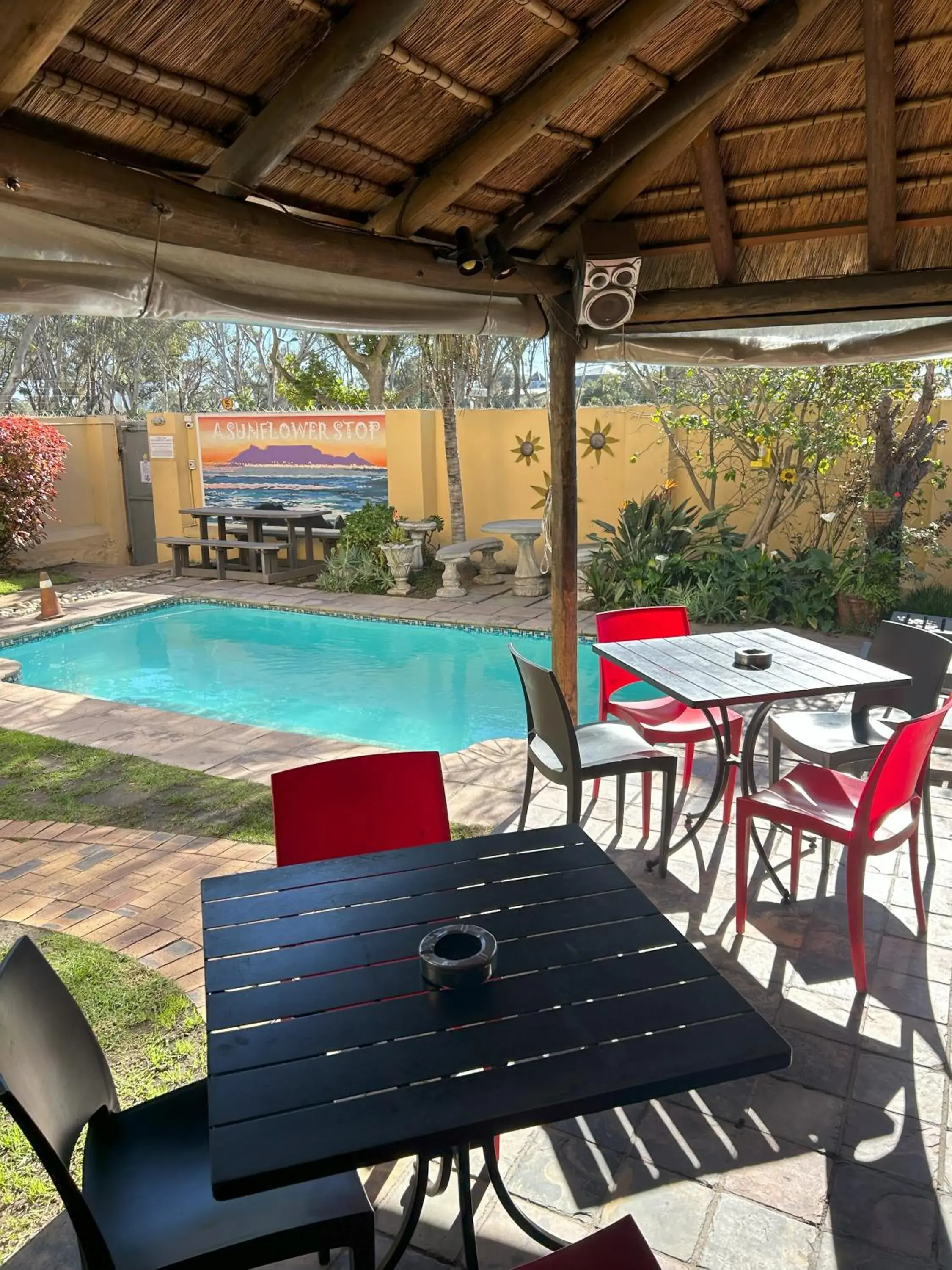 Patio, Swimming Pool in A Sunflower Stop Backpackers