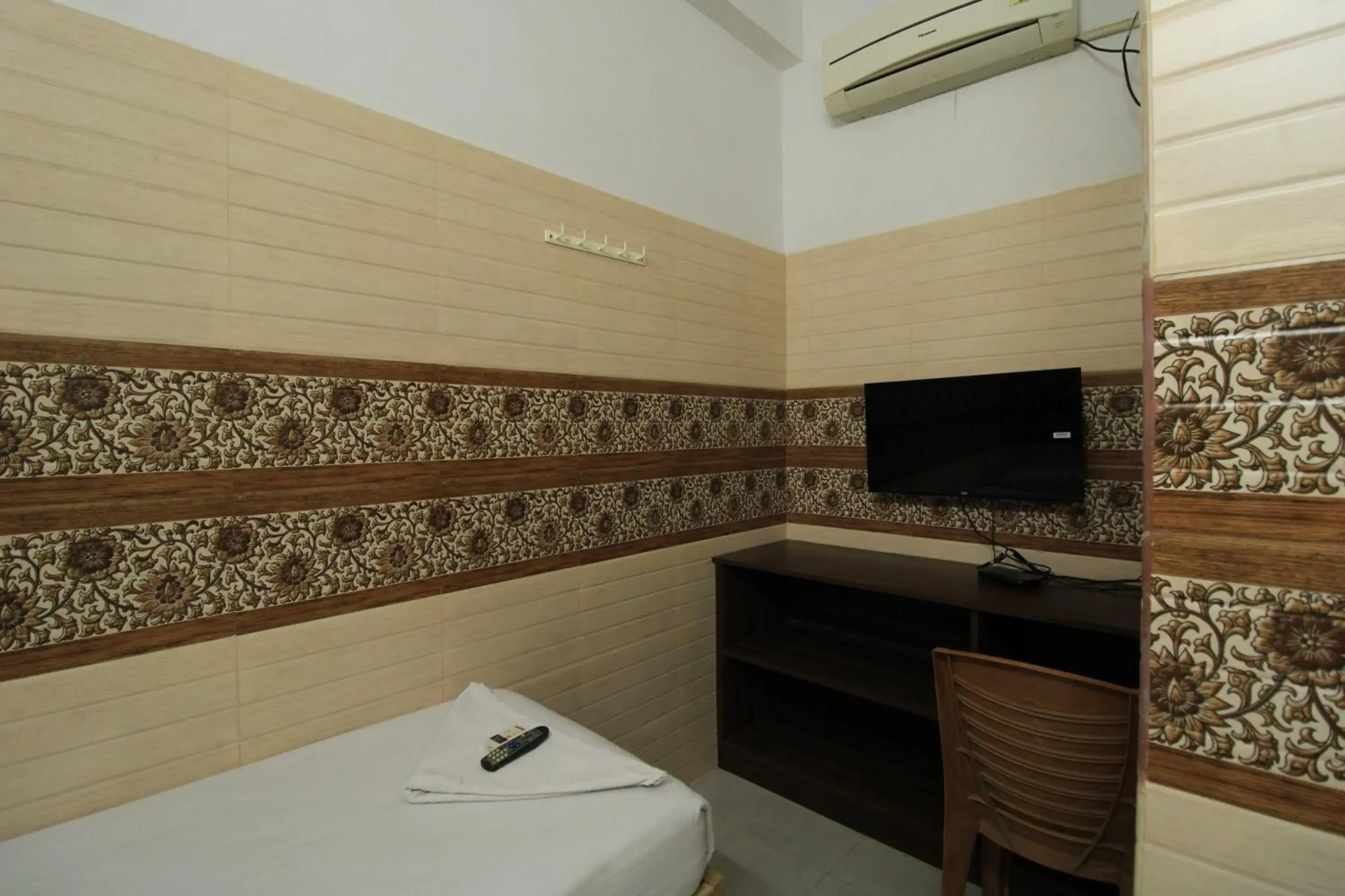 Bed, TV/Entertainment Center in Just Guest House