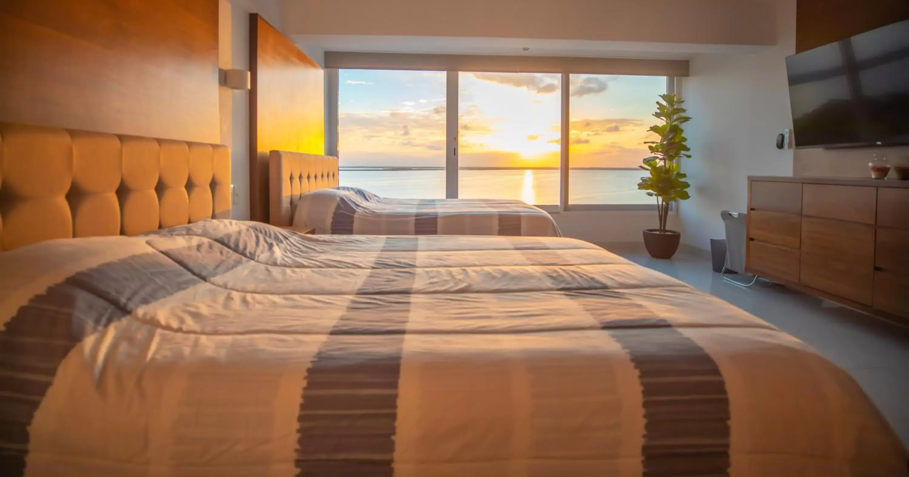 Bed in Beachfront Penthouses by LivIN Cancun