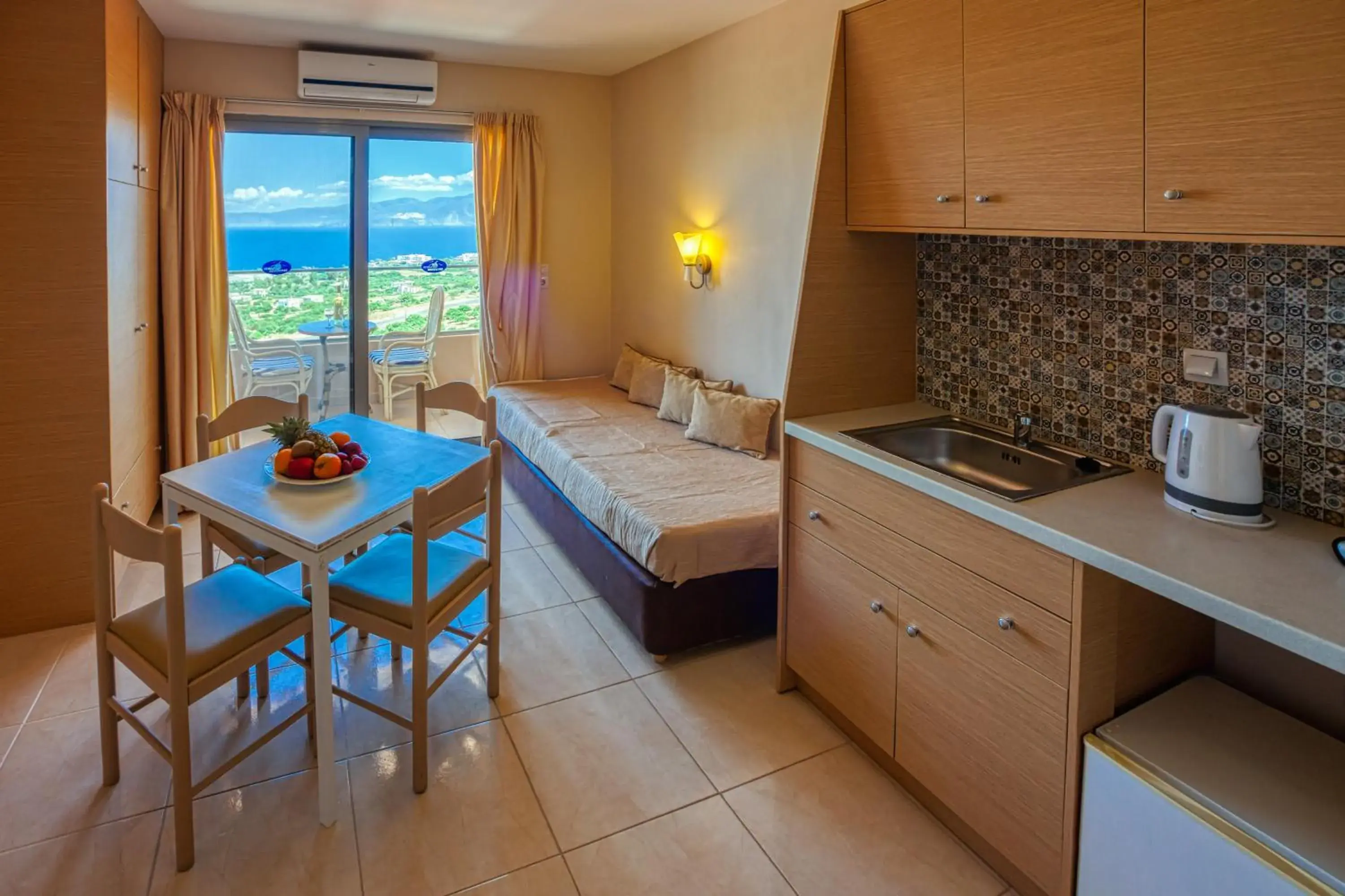 Bed, Kitchen/Kitchenette in Elounda Water Park Residence Hotel