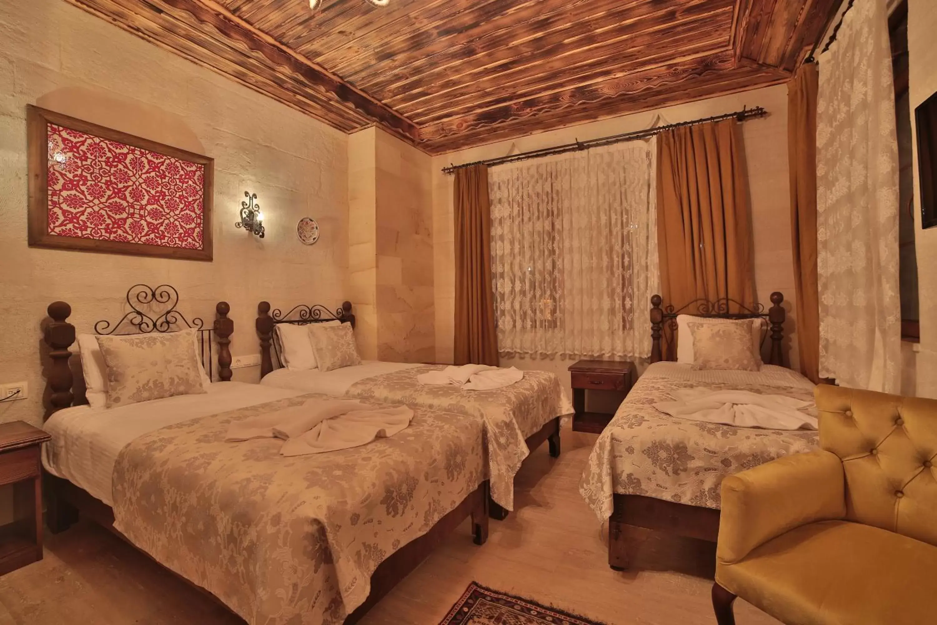 Bed in Caravanserai Inn Hotel