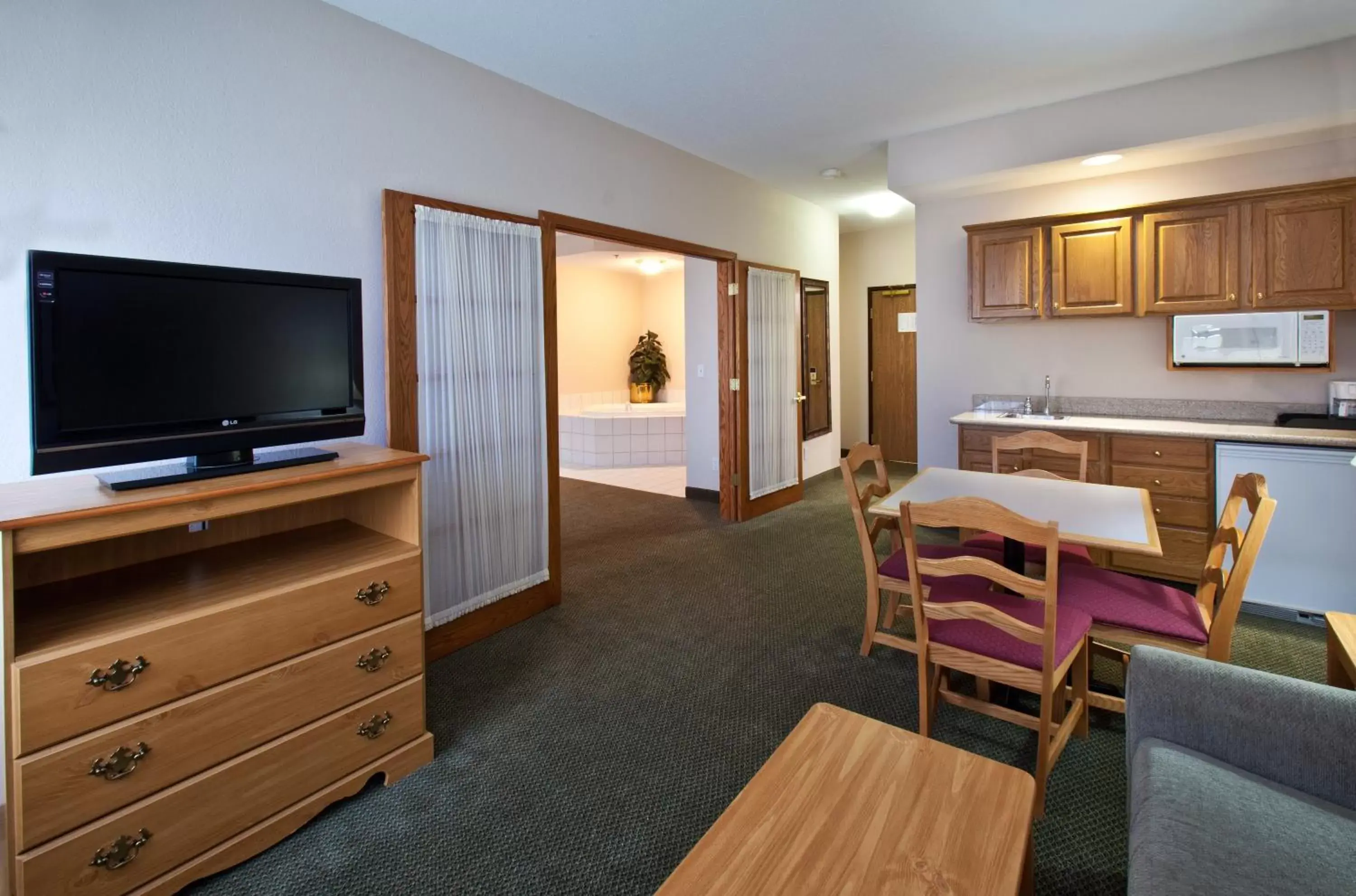 Photo of the whole room, TV/Entertainment Center in GrandStay Hotel & Suites Pella