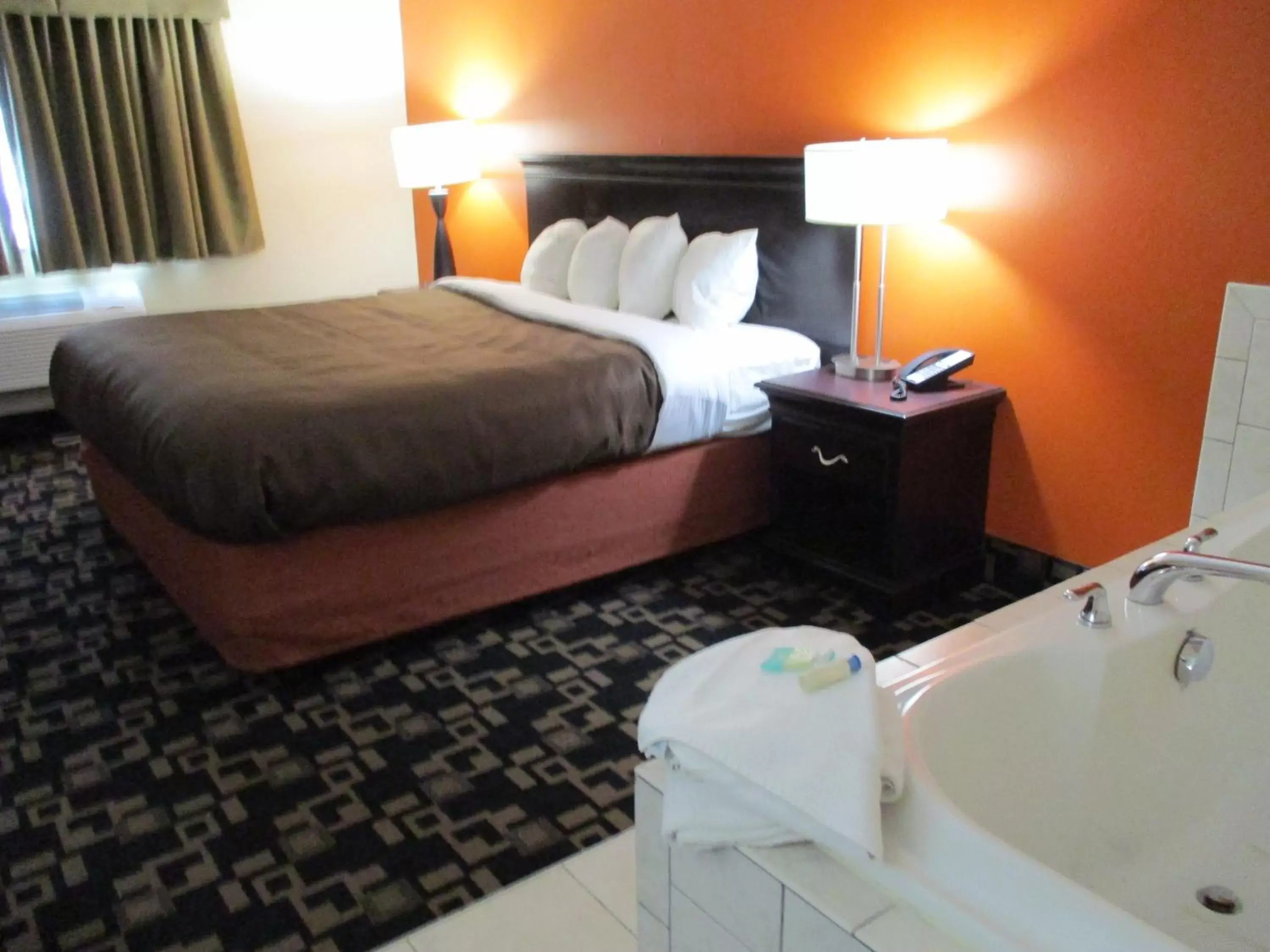 Bed in AmericInn by Wyndham Wausau