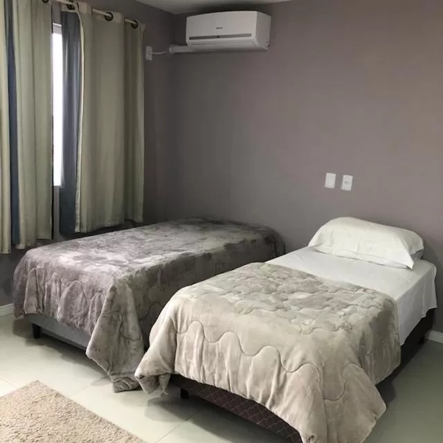 Bed in Pousada Mercosul