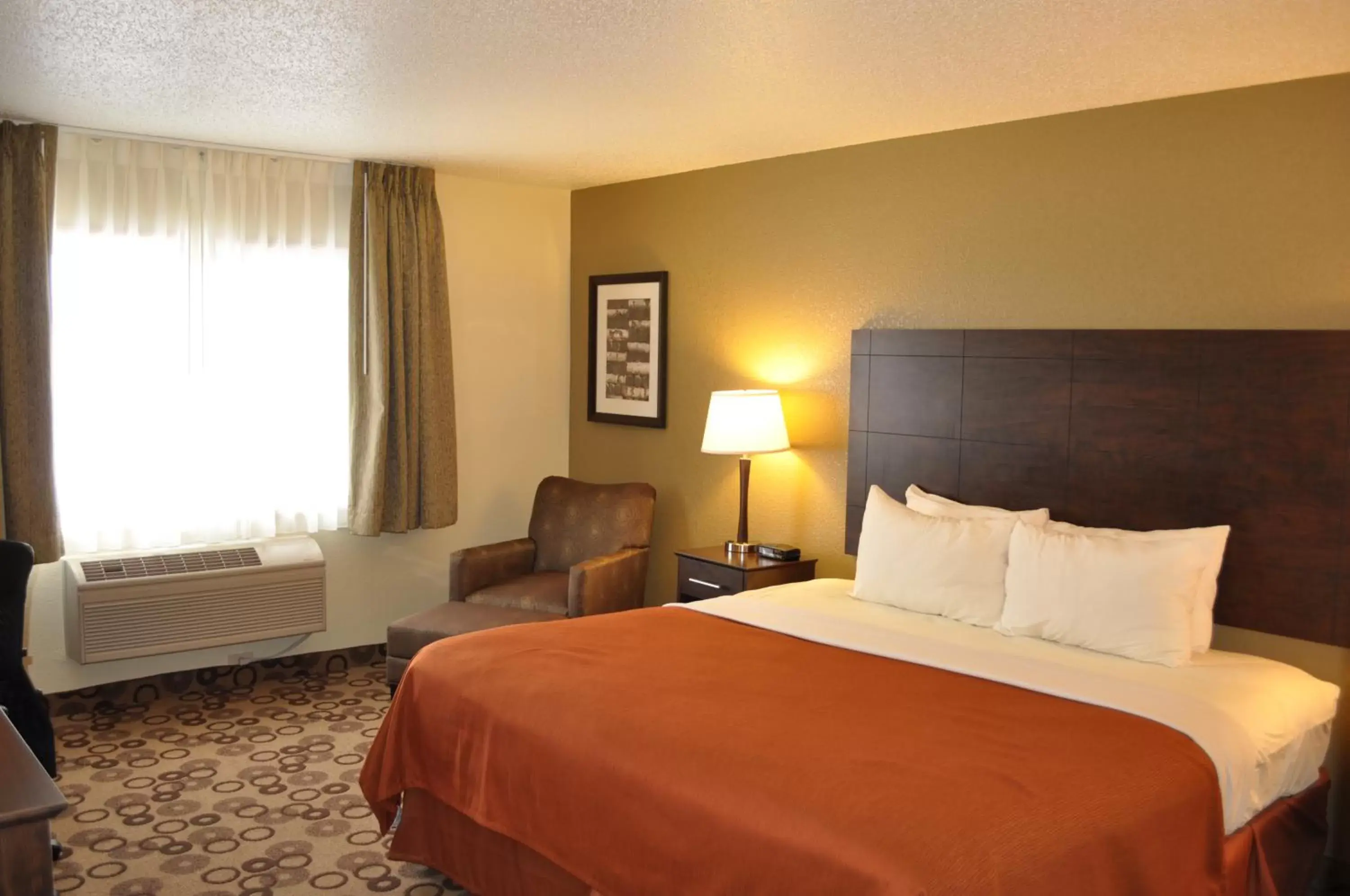 Bed in AmericInn by Wyndham Cedar Falls