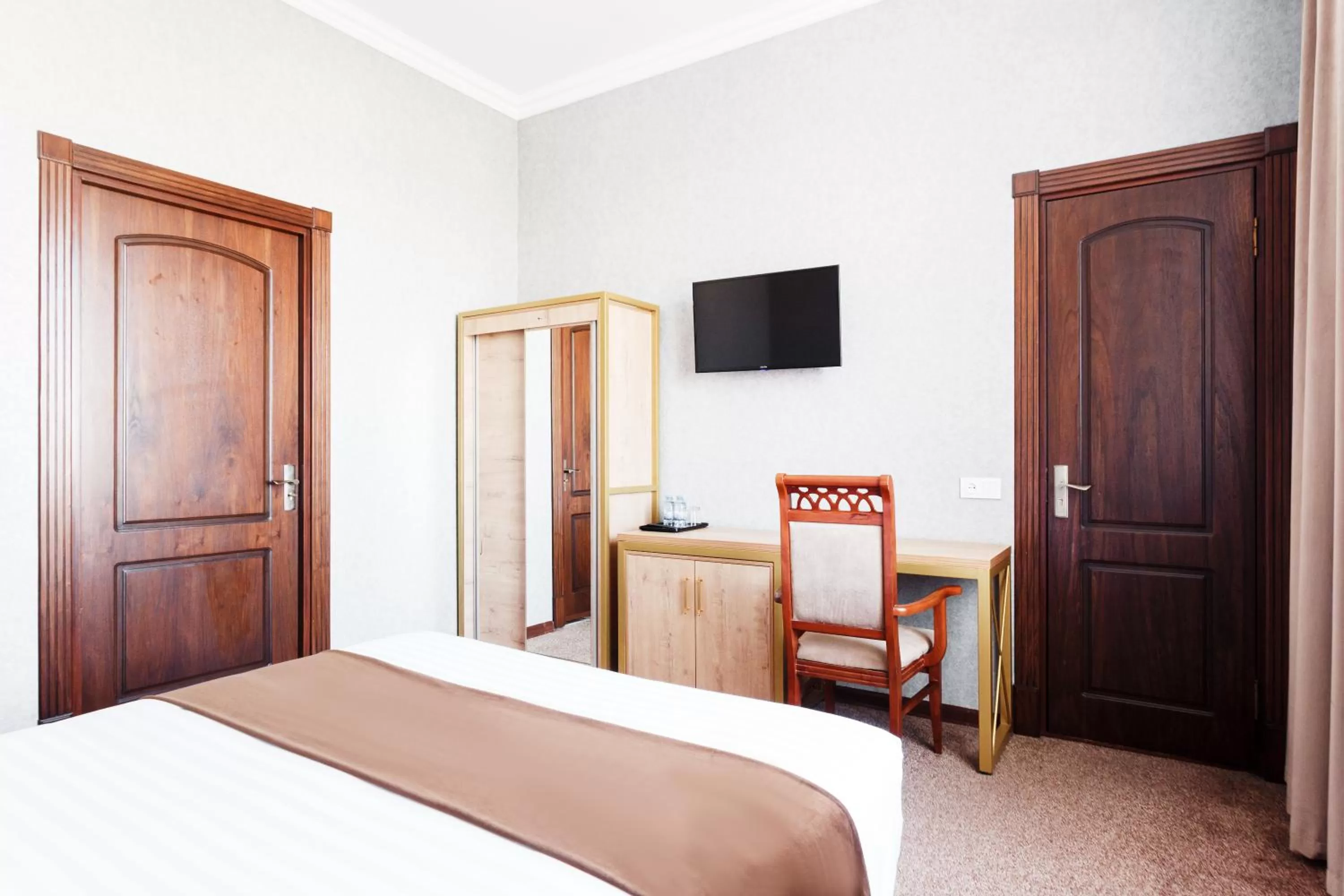 Bed in Western Suites Hotel