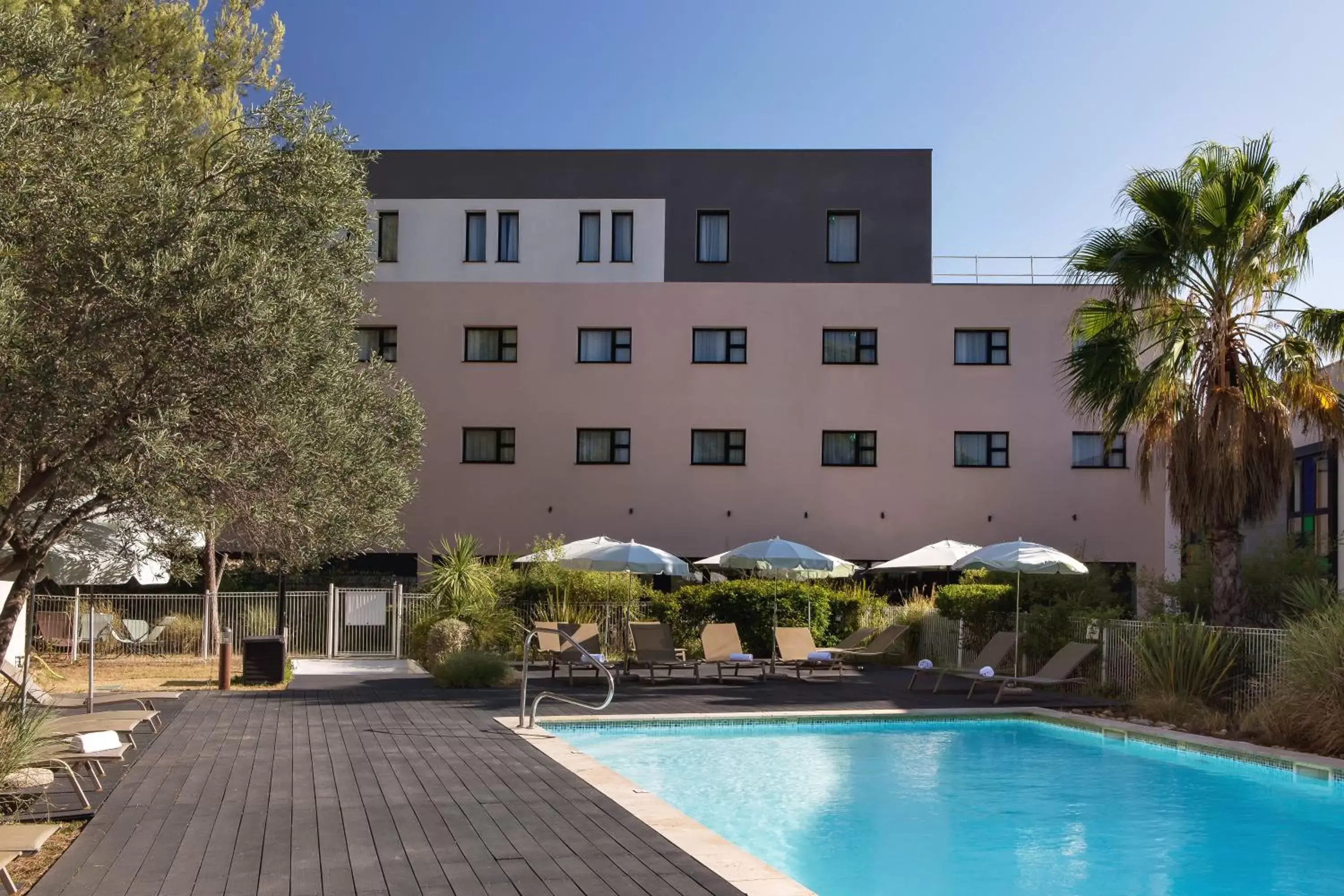 Swimming pool, Property Building in Holiday Inn - Marseille Airport, an IHG Hotel