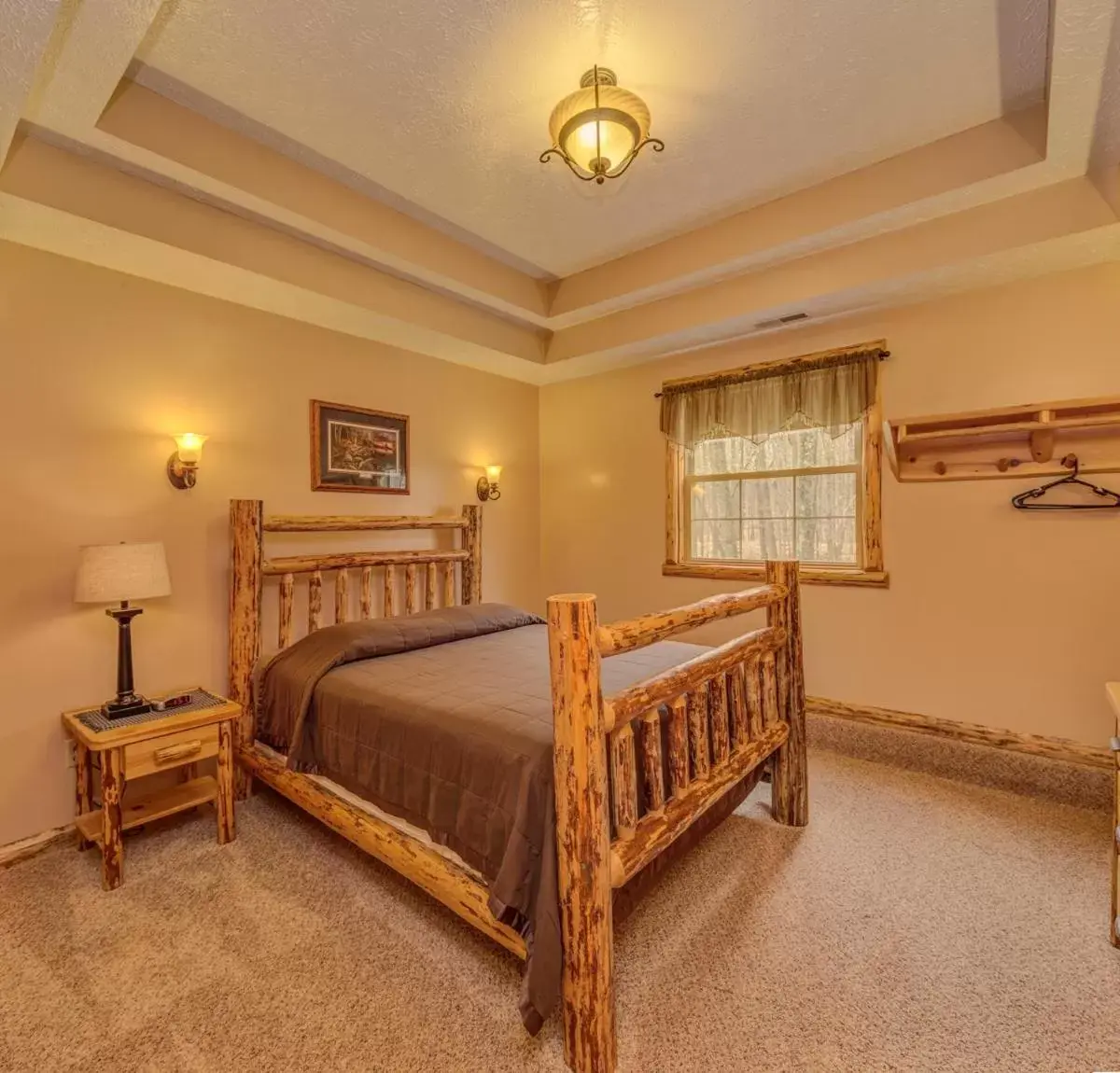 Bed in Sojourner's Lodge & Log Cabin Suites