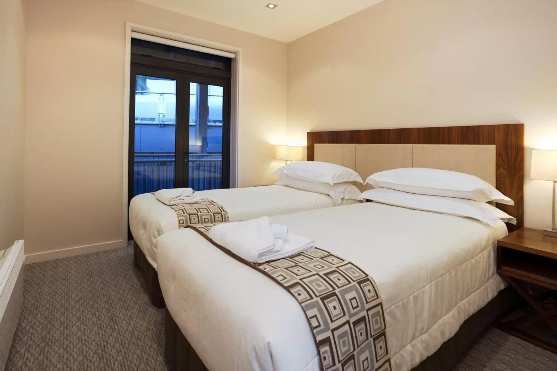 Bed in The Rees Hotel & Luxury Apartments