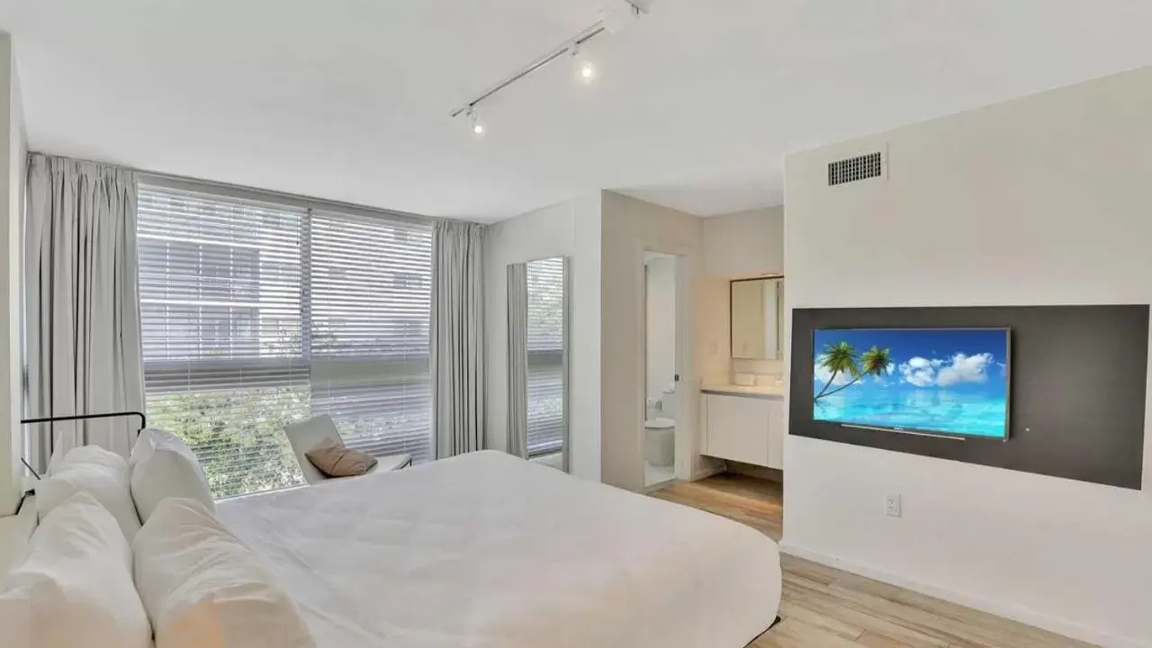 Bedroom, TV/Entertainment Center in Beach Haus Key Biscayne Contemporary Apartments
