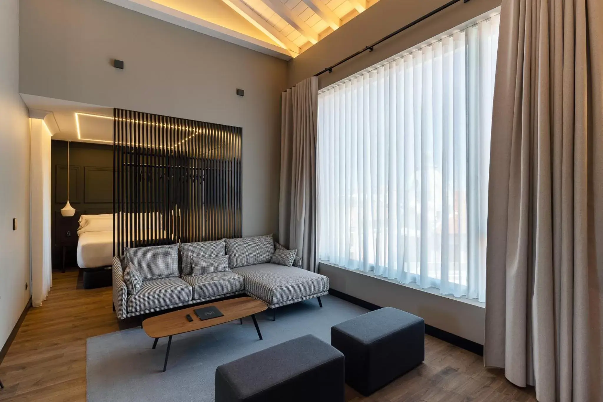 Bed, Seating Area in Mauro Suites