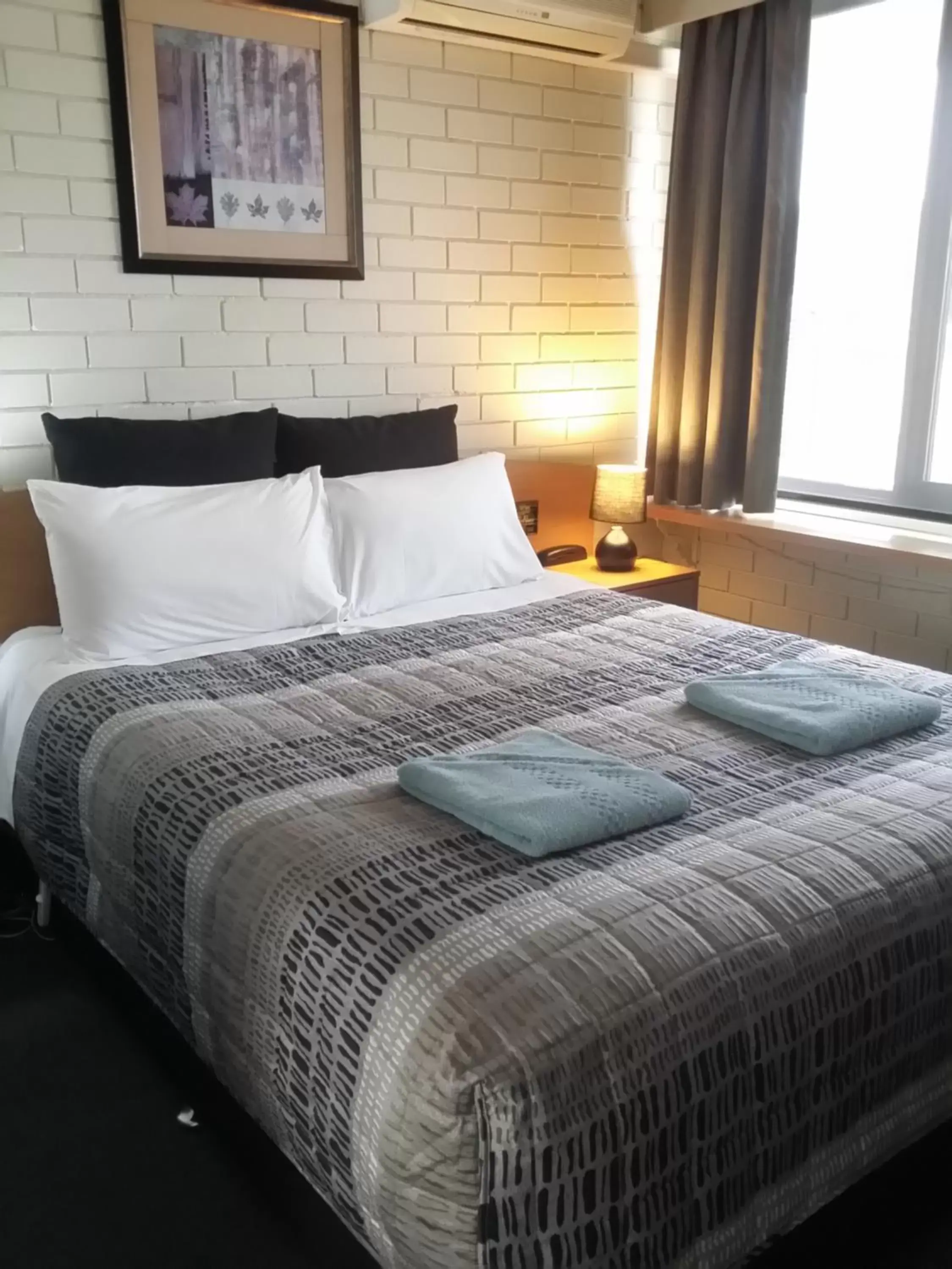 Bed in White Manor Motel