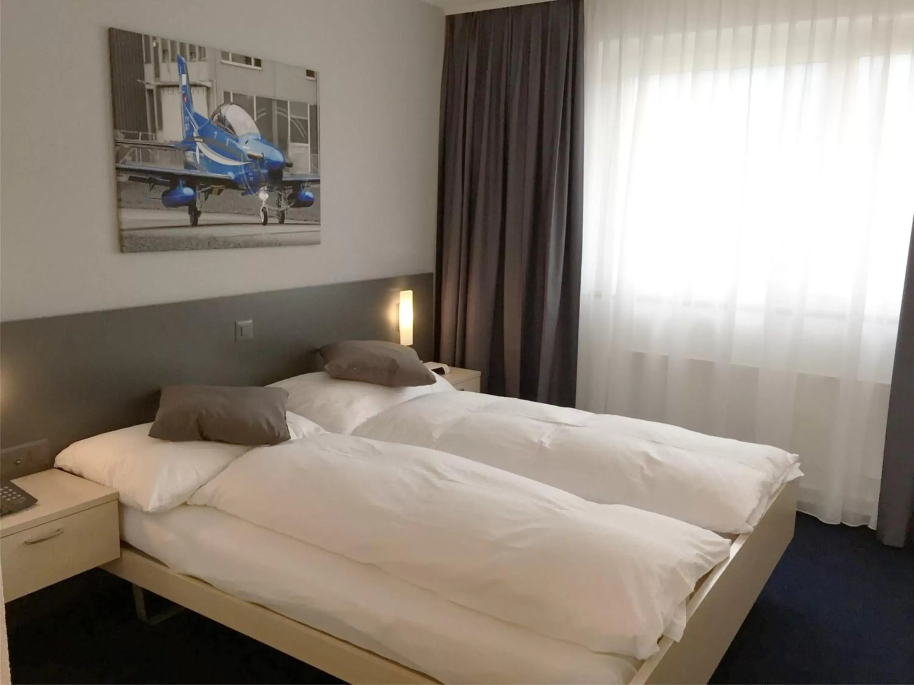 Photo of the whole room, Bed in Airporthotel Grenchen