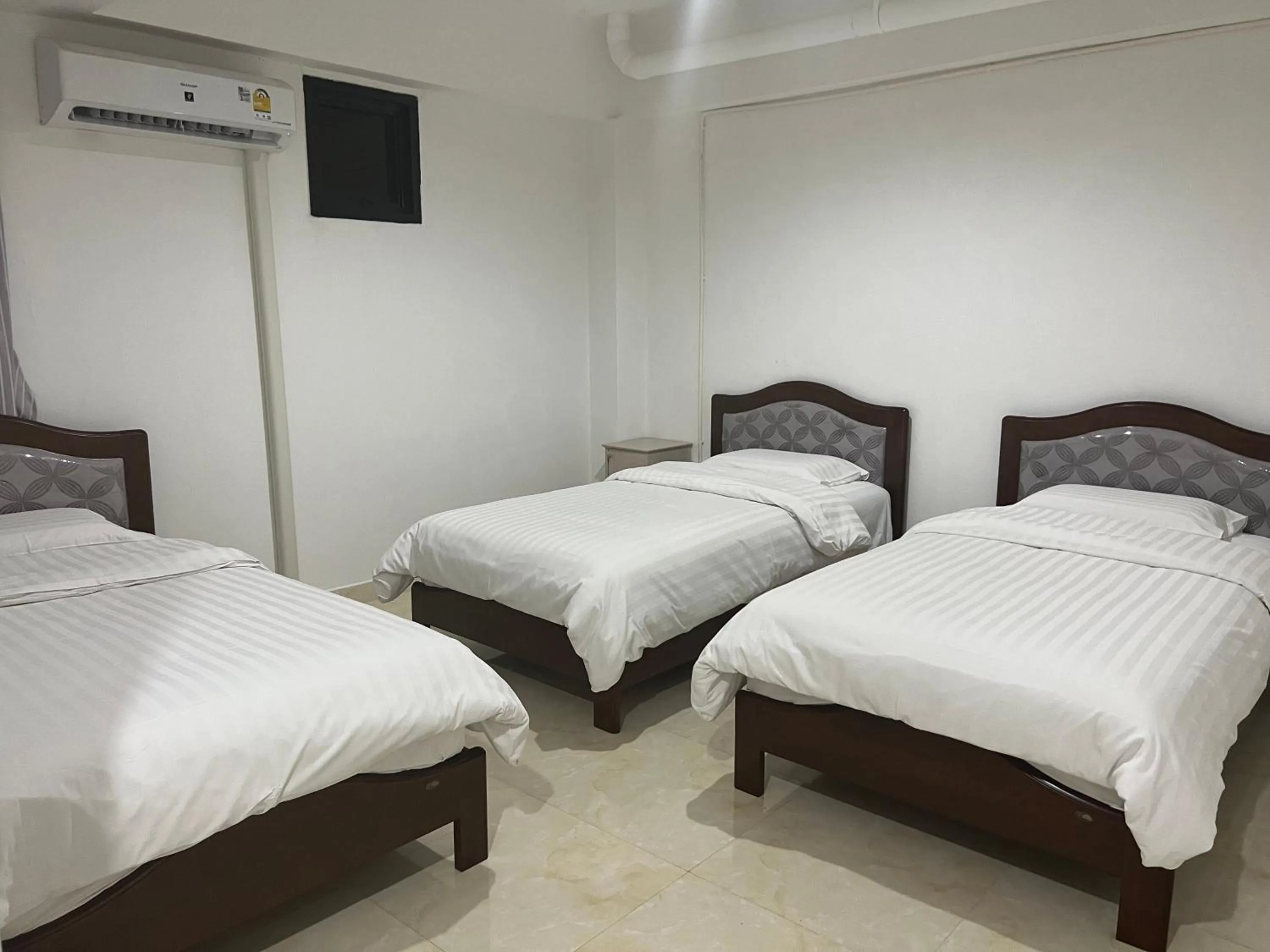 Bed in Mall Suites Hotel