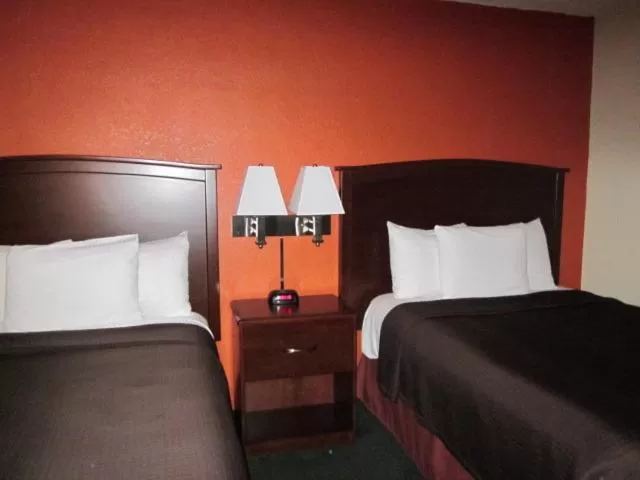 Bed in AmericInn by Wyndham Plymouth