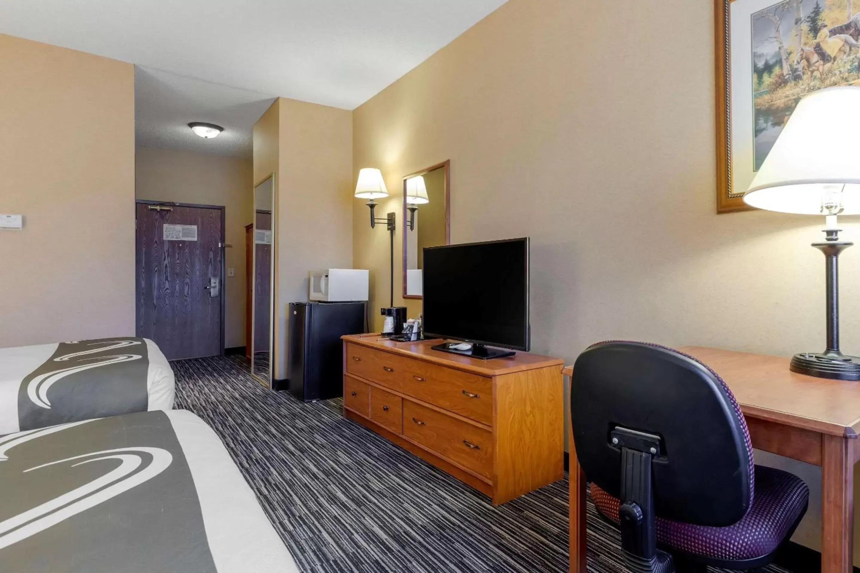 Bedroom, TV/Entertainment Center in Quality Inn & Suites Wellington – Fort Collins
