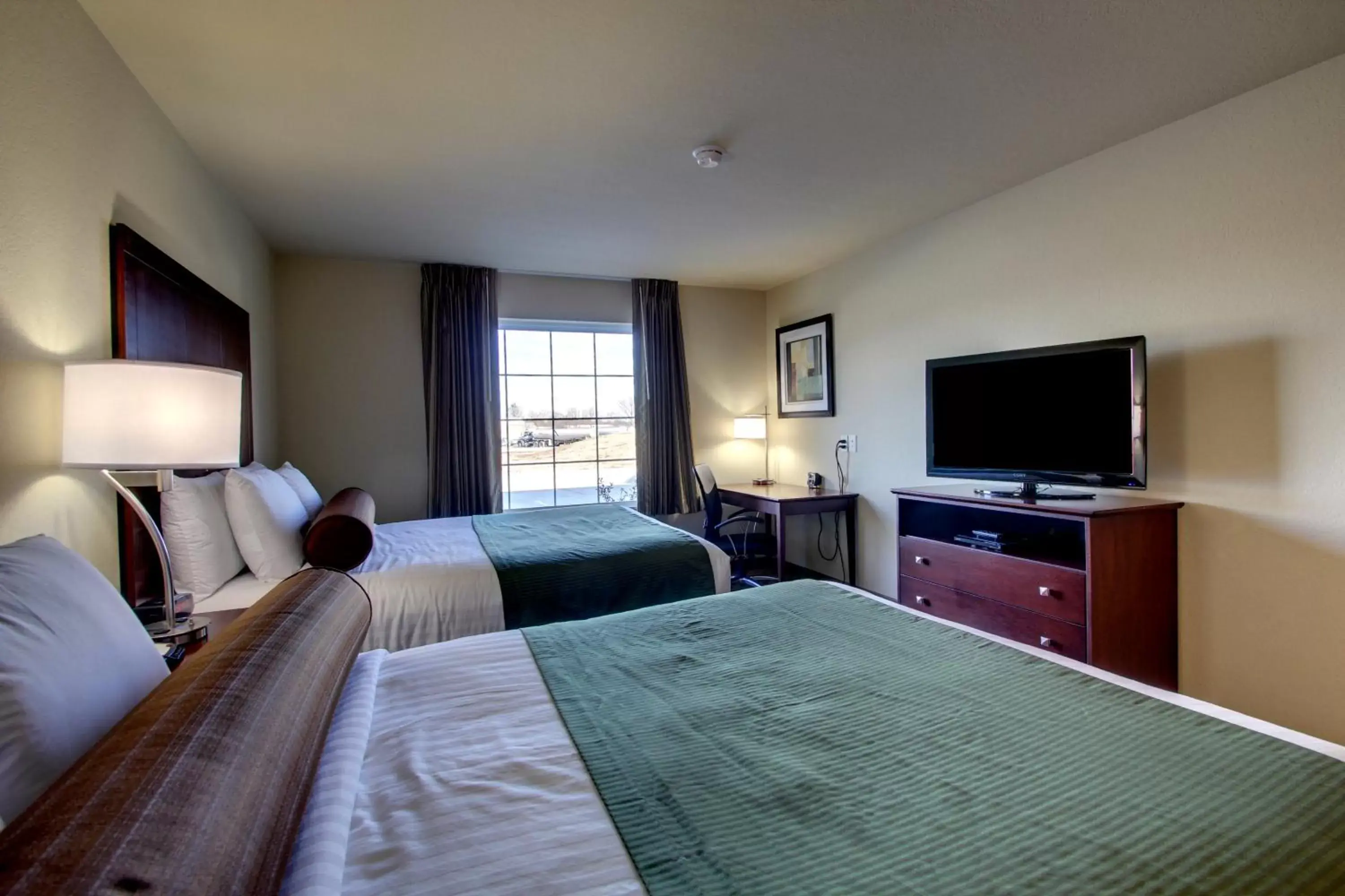 Bed, TV/Entertainment Center in Cobblestone Inn & Suites - Harvey