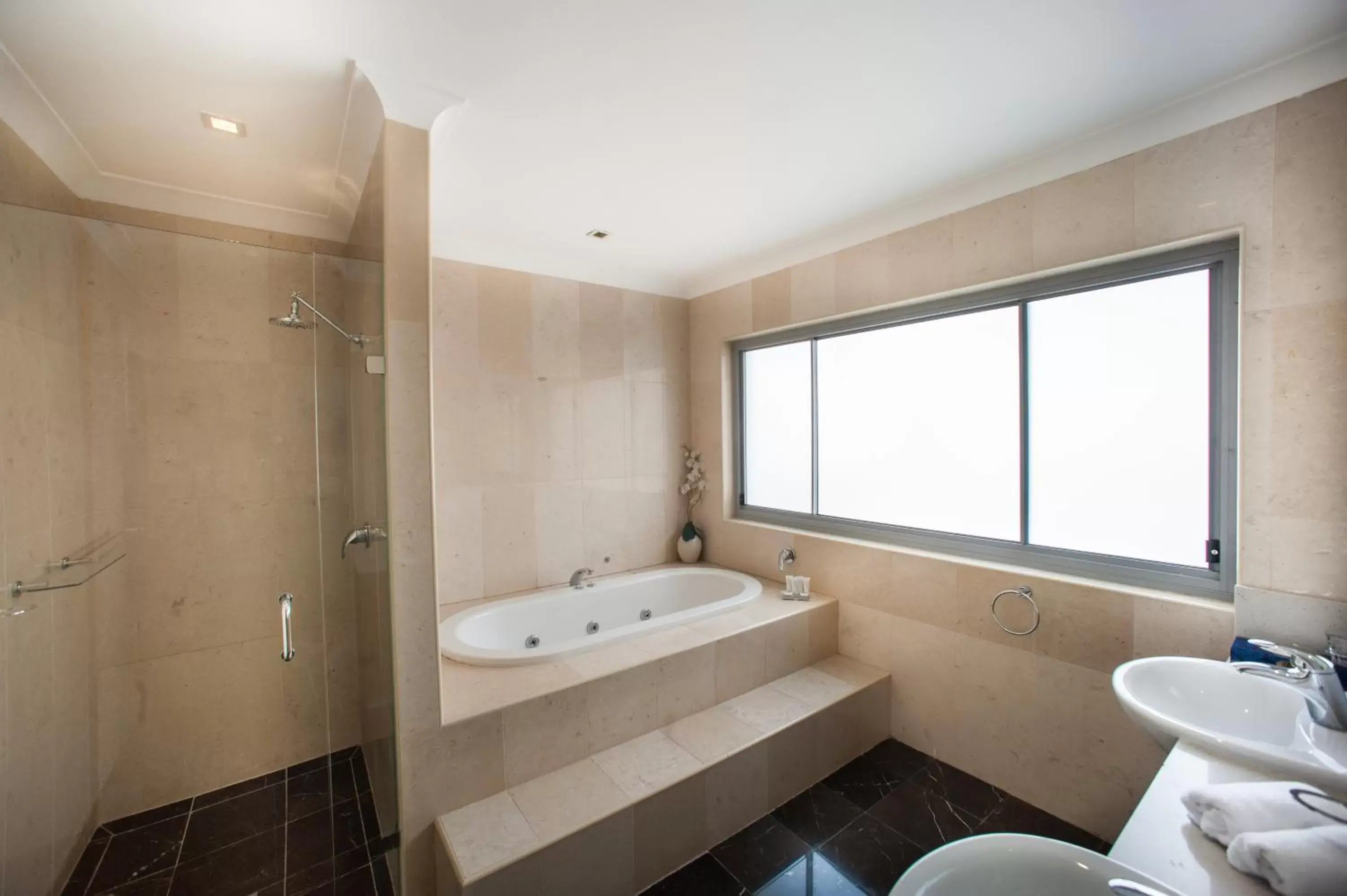 Bathroom in Ramada Hotel & Suites by Wyndham Cabramatta